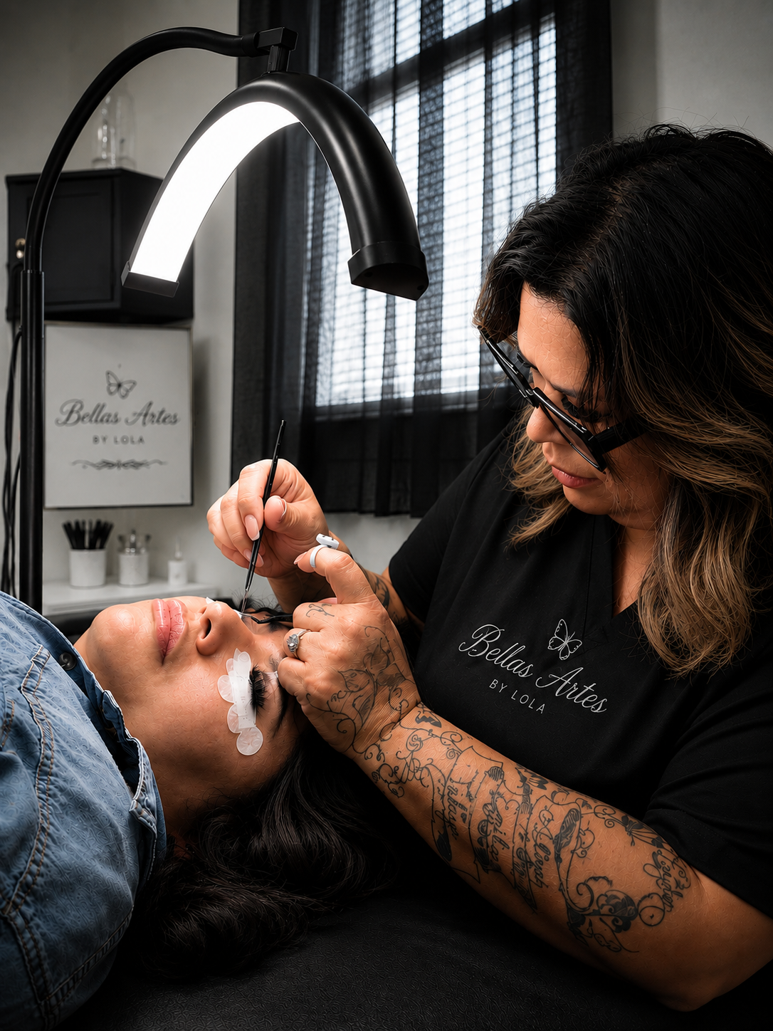 Tattoo artist working on a client's face in a tattoo studio