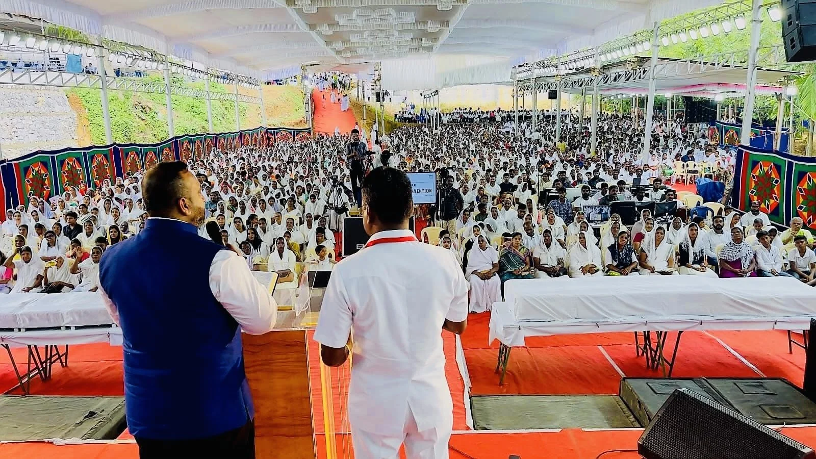 Rev. Mathew is preaching to a large crowd in India. 