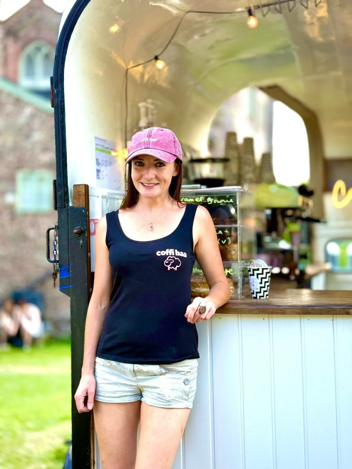 Photograph of female owner standing in front of her coffee horsebox business