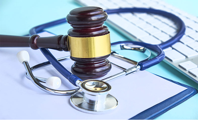 gavel and stethoscope on clipboard