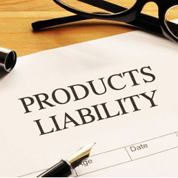 A document titled 'Products Liability' on a wooden surface, accompanied by a black pair of glasses, a fountain pen, and a magnifying glass.