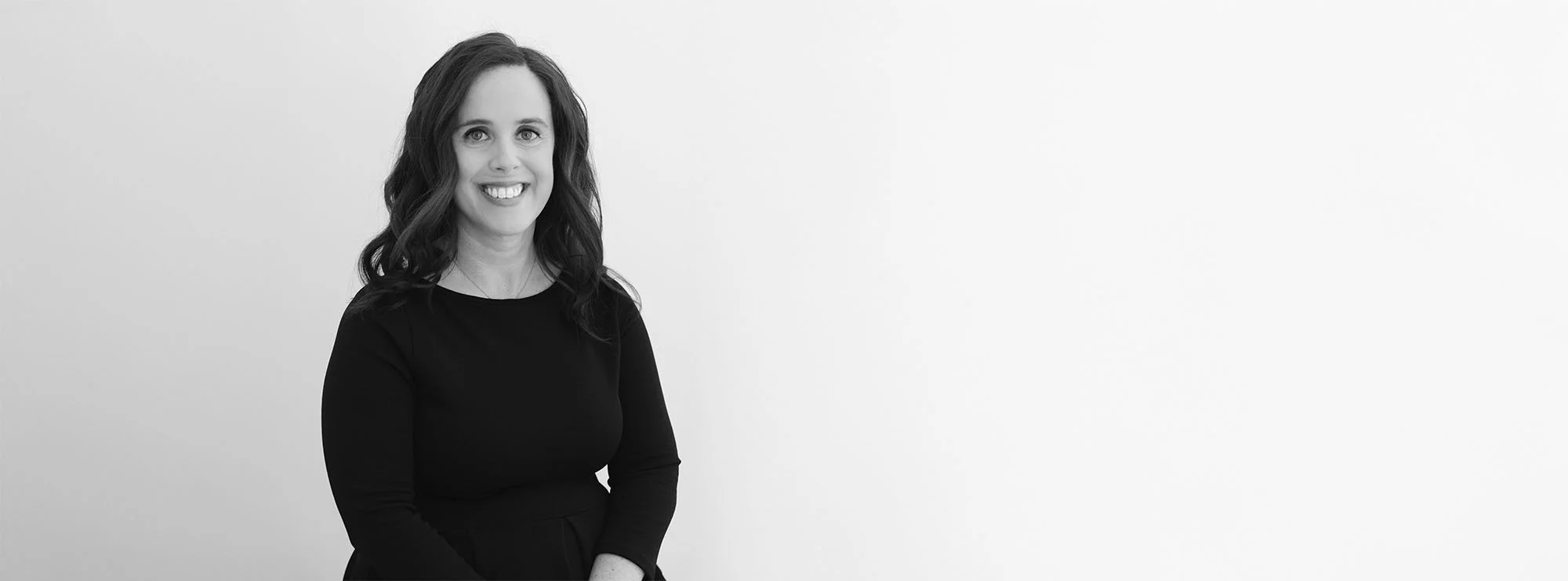 Wide black and white professional headshot of Amanda Turnage, Partner at Loftin Holt Hall & Hargett LLP.