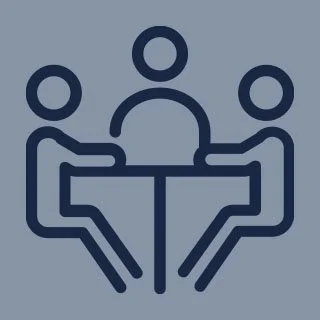 Line drawing of three people sitting around a table.