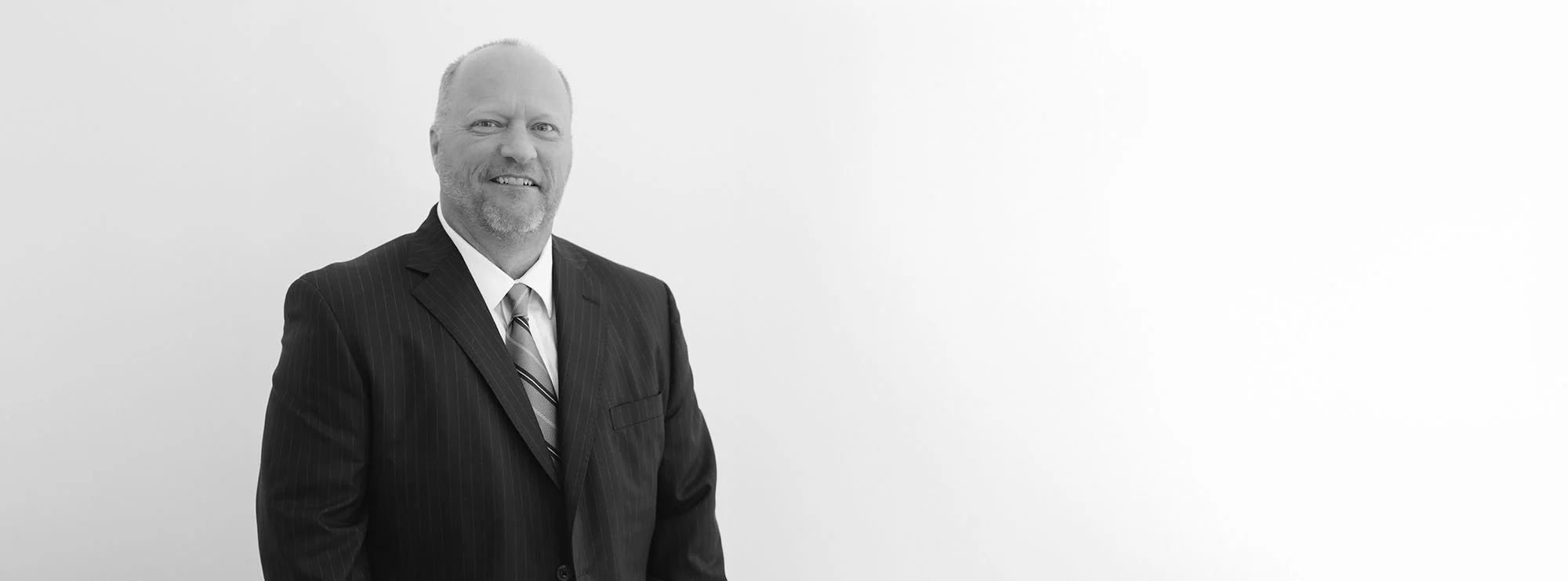 Black and white professional headshot of Bartley Loftin, Founding Partner at Loftin Holt Hall & Hargett LLP.