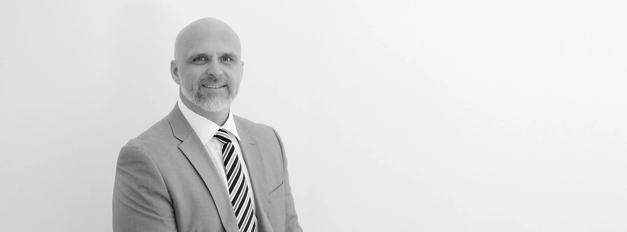 Wide black and white professional headshot of Douglas Hargett, Partner at Loftin Holt Hall & Hargett LLP.