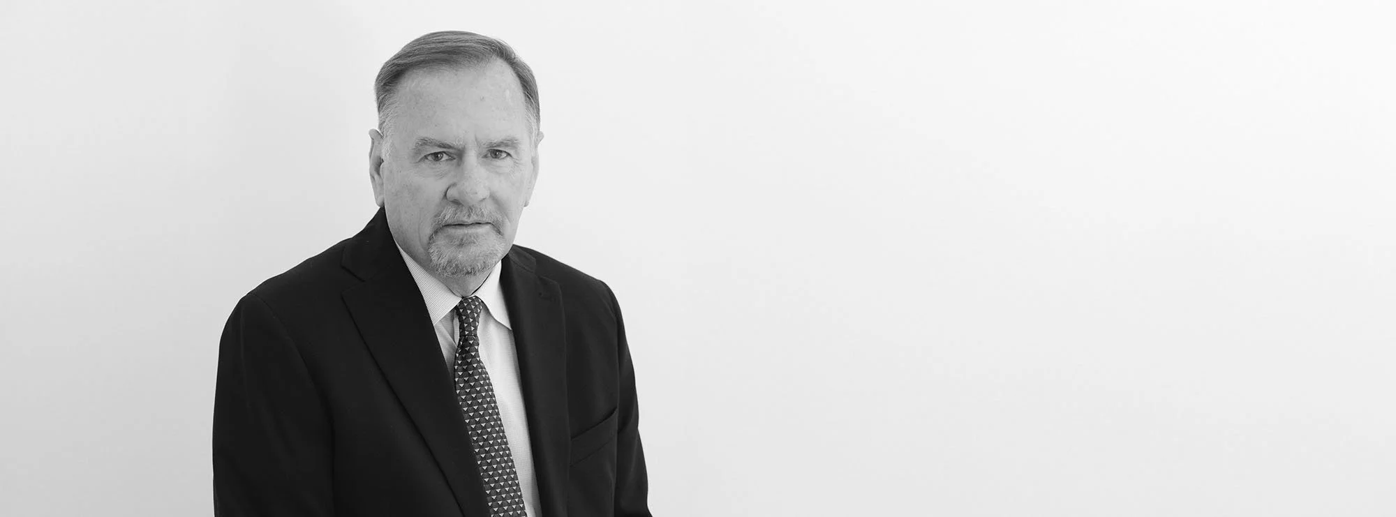 Black and white wide professional headshot of Michael Tanner, Of Counsel at Loftin Holt Hall & Hargett LLP.