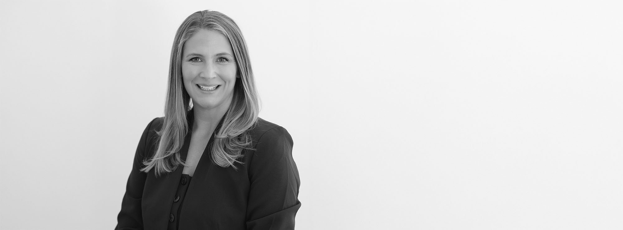 Wide black and white professional headshot of Angela Schaefer, Partner at Loftin Holt Hall & Hargett LLP.