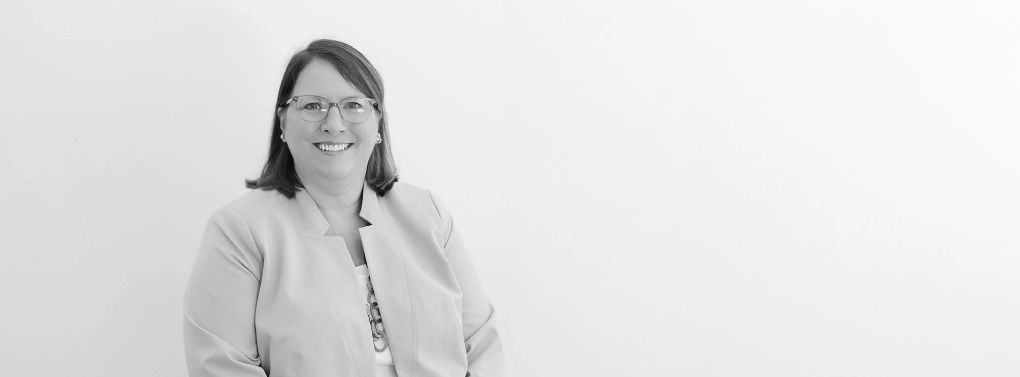 Black and white wide professional headshot of Elizabeth Hamrick, Of Counsel at Loftin Holt Hall & Hargett LLP.