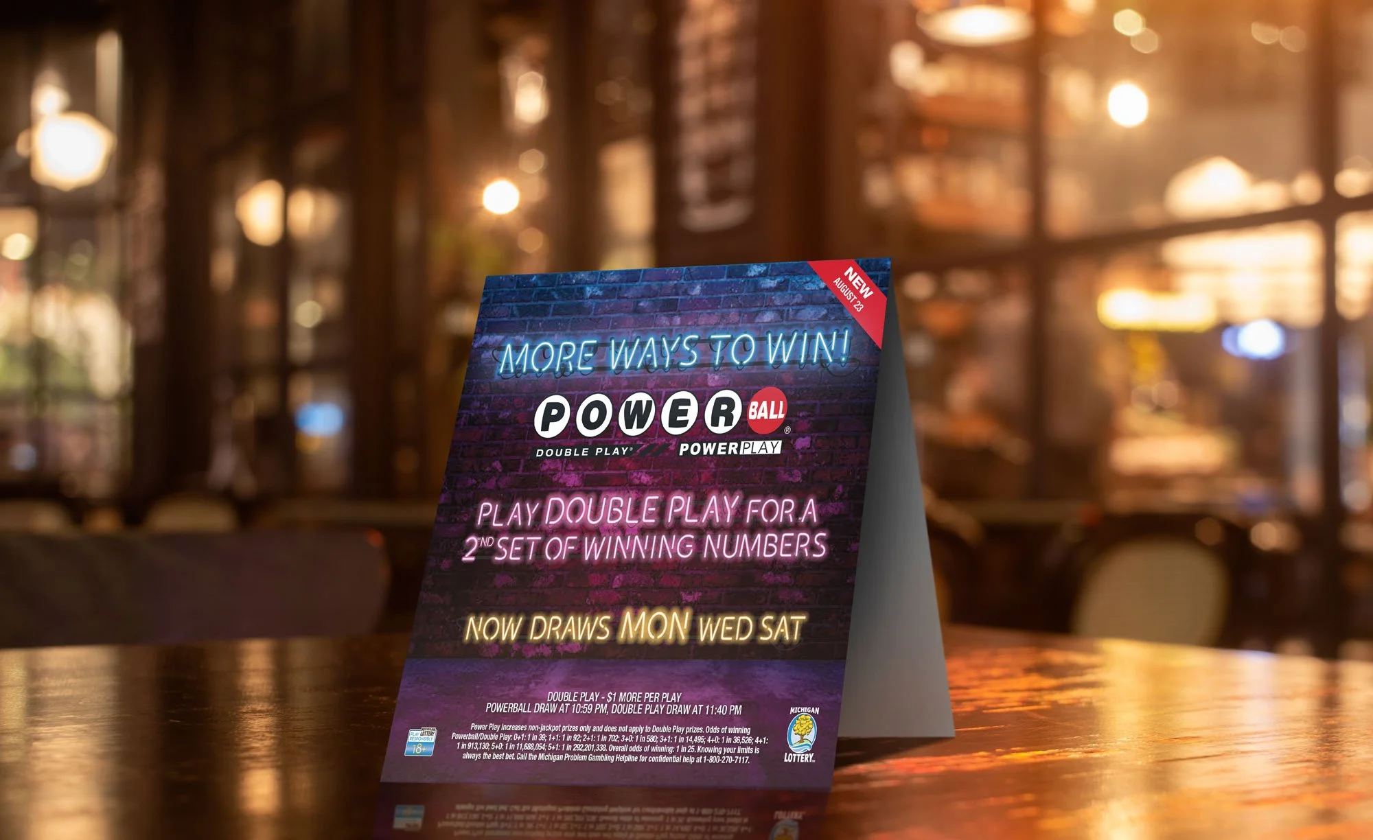A table tent for Powerball Doubleplay from the Michigan Lottery. Headline reads, "More ways to win! Play Double Play for a 2nd set of winning numbers".