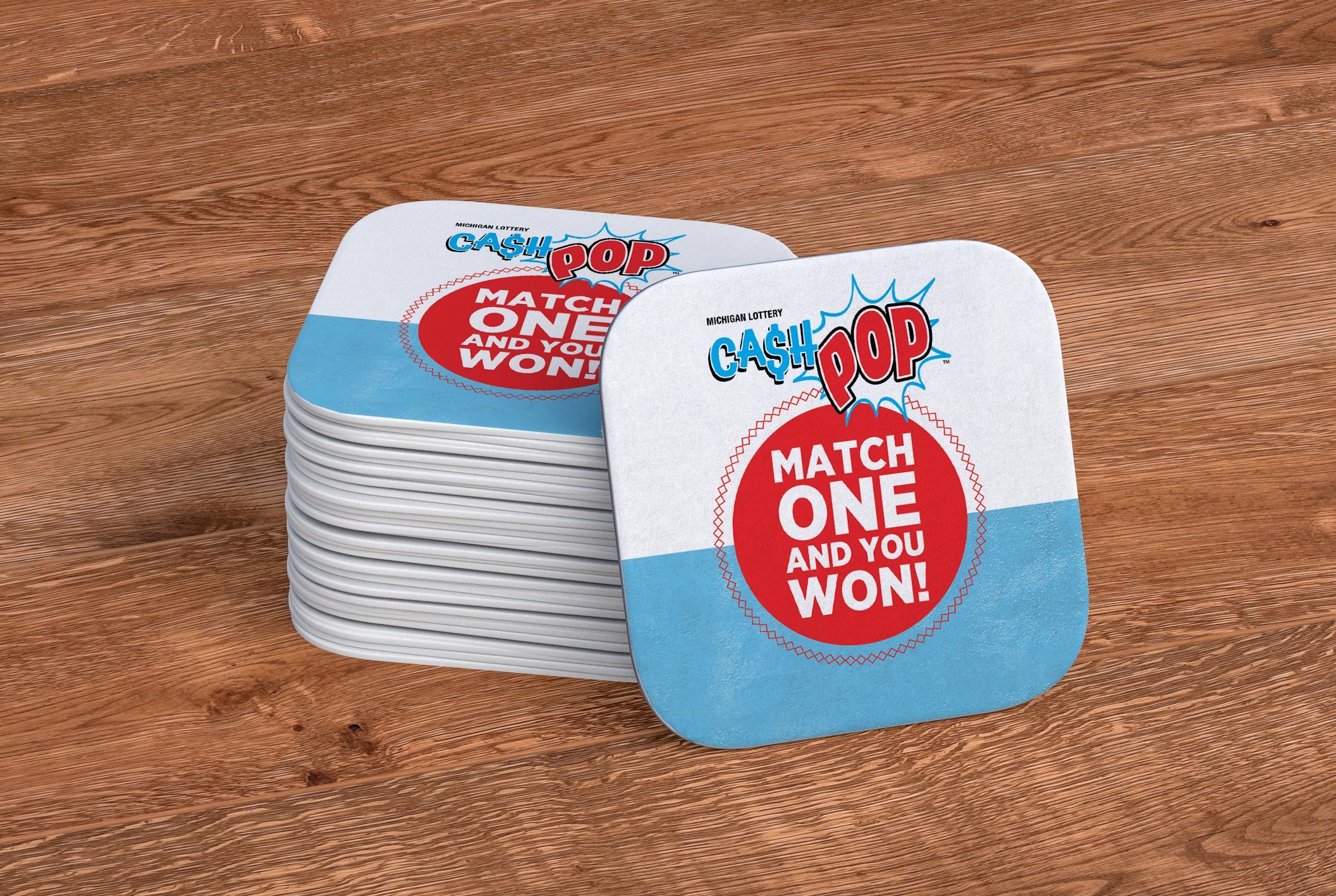 Michigan Lottery Cash Pop branded coasters. The message says, "Match one and you won!"
