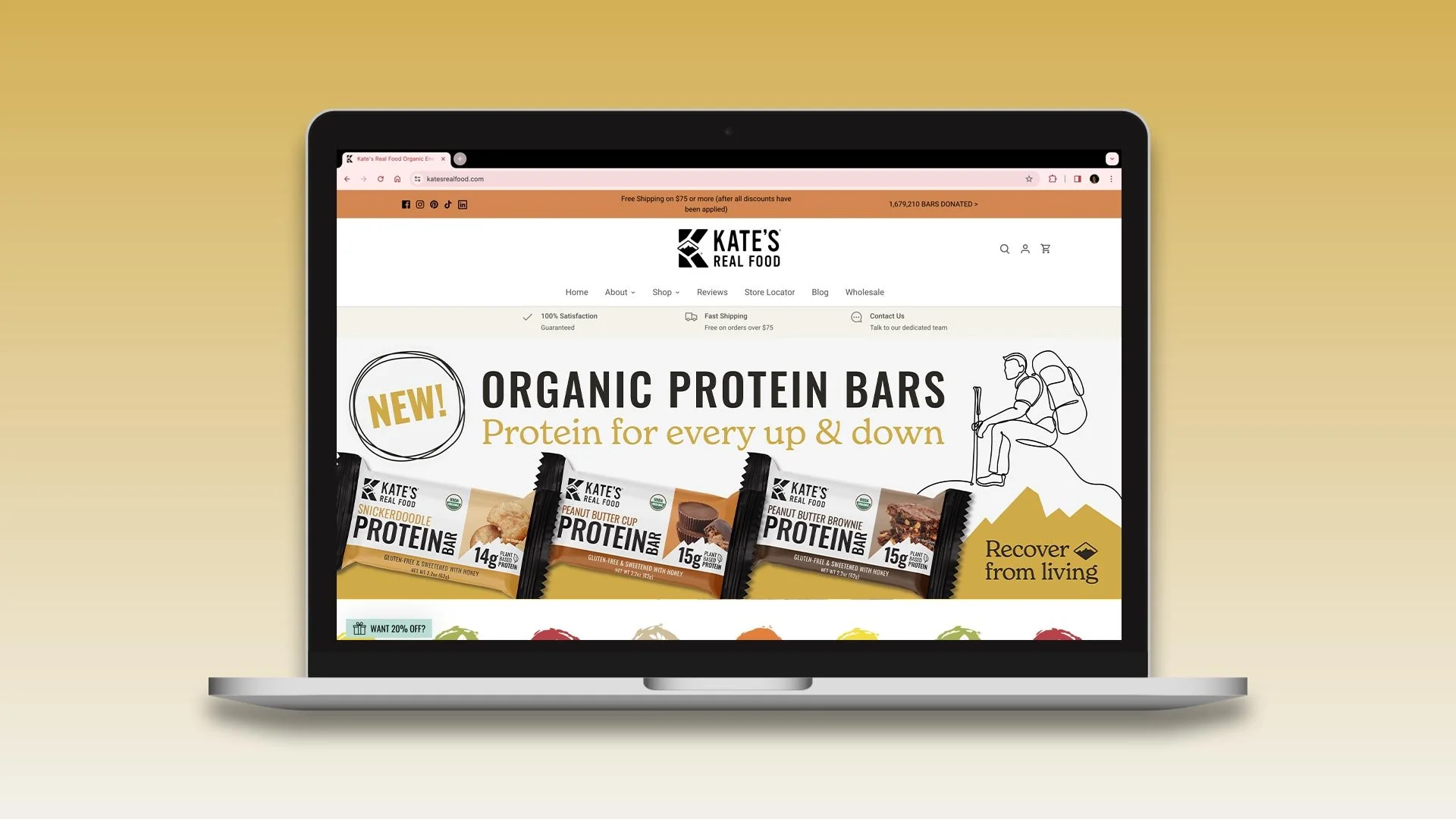 A laptop showing the Kate's Real Food website with the new Organic Protein Bar header image.