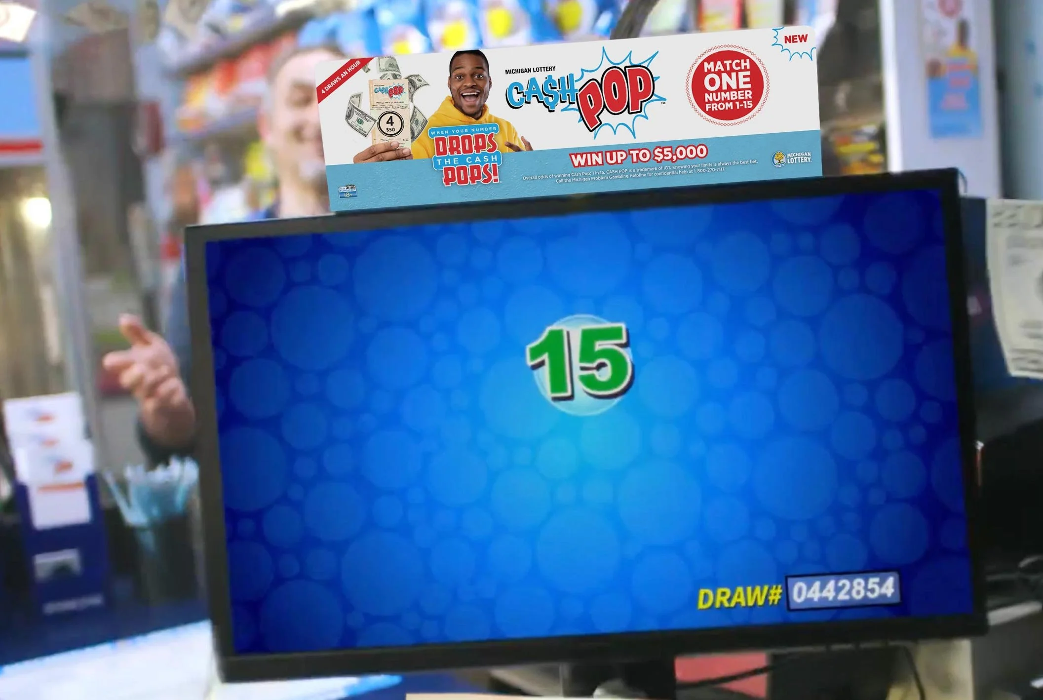 A Michigan Lottery Cash Pop monitor topper for retailer locations.