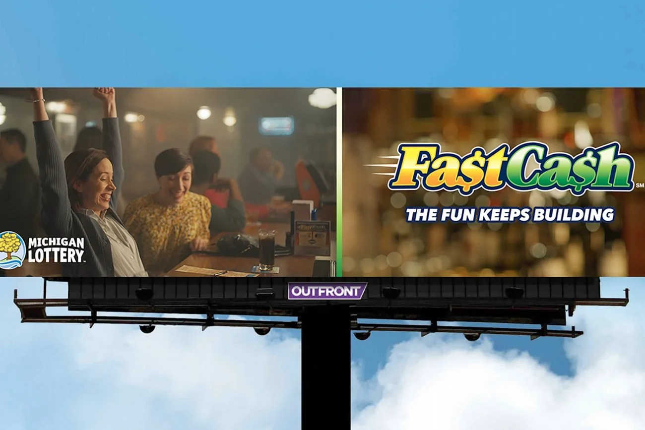 A billboard for Fast Cash. "The fun keeps building."