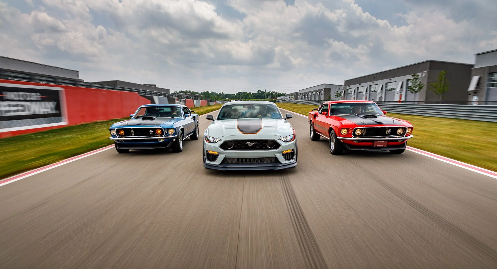 An image of 3 different Ford Mustangs driving towards the camera.