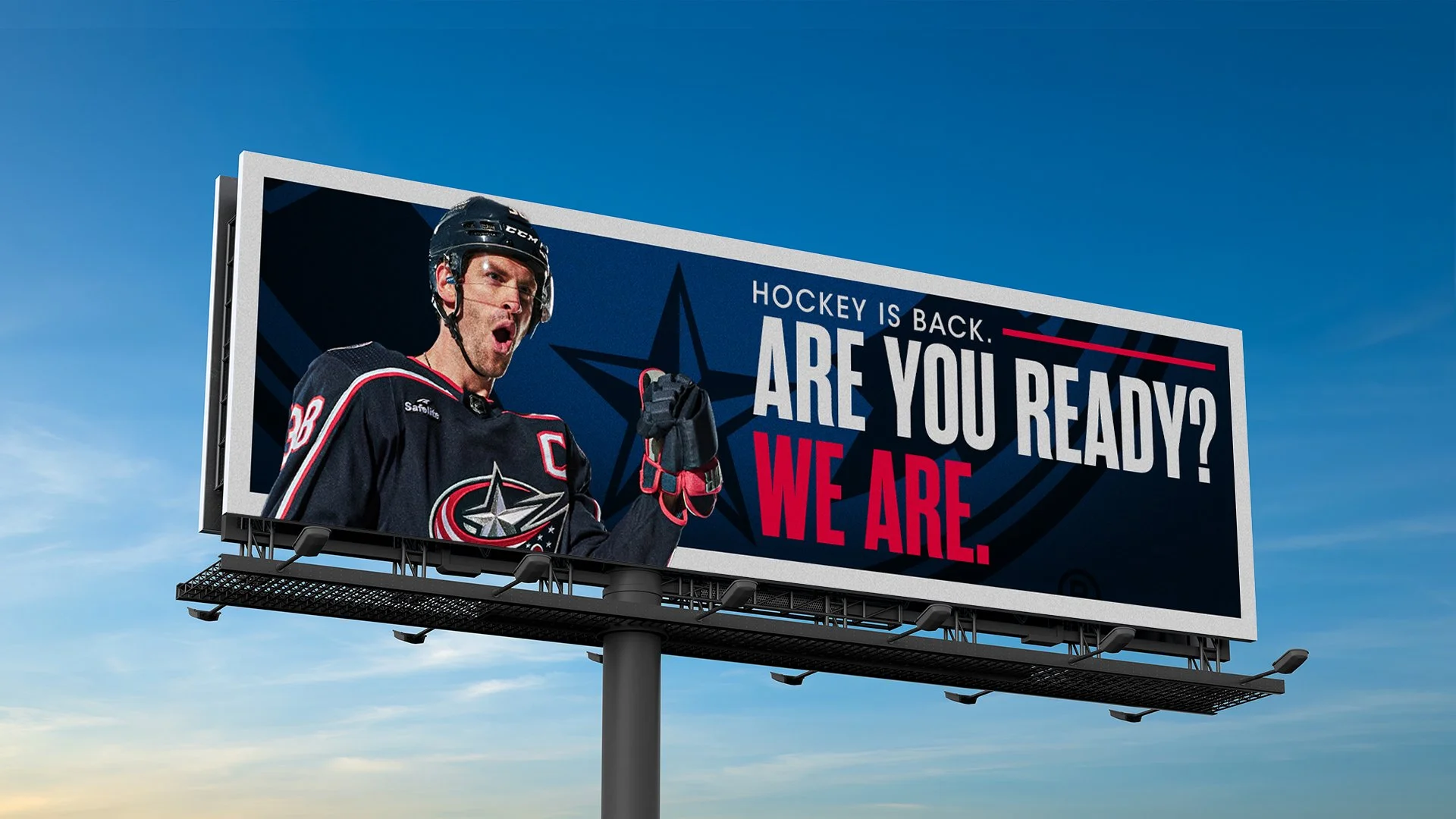 An OOH billboard of a Columbus Blue Jackets player next to the headline, "Hockey is Back. Are you ready? We are."