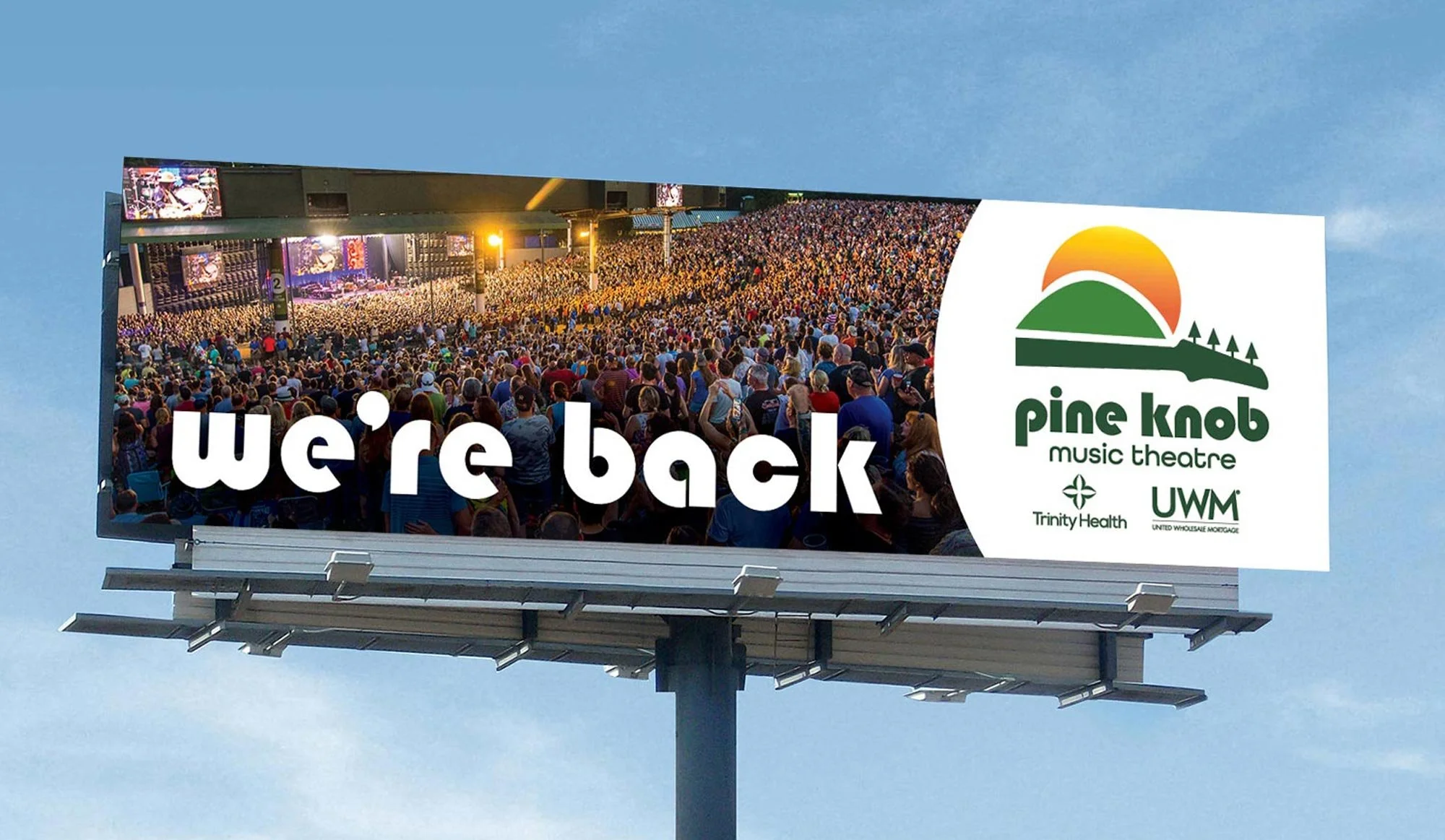A Pine Knob Music Theatre showing a photo of a crowd with the headline, "we're back."