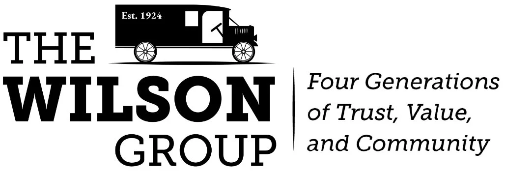 Logo for The Wilson Group featuring a vintage train car and the text 'Est. 1924. The Wilson Group. Four Generations of Trust, Value, and Community.'
