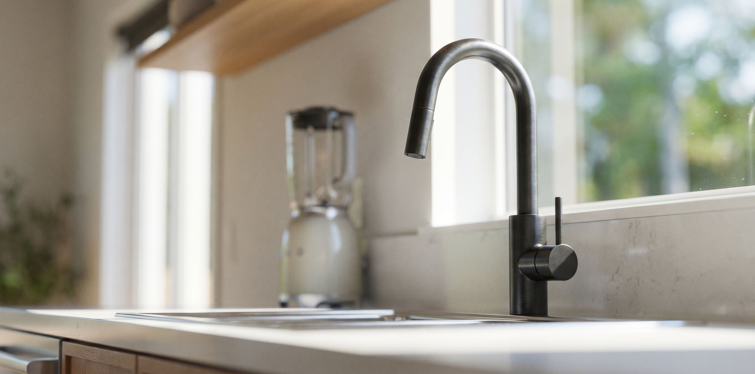 Close-up of a modern kitchen sink with a stainless steel faucet by a window, with blurred background including a blender and greenery outside.