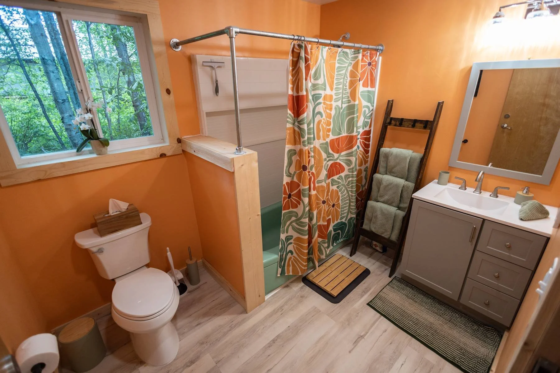 Spacious shared bathhouse bathroom (one of two shared bathrooms a few steps away from your cabin) with heated floors, vintage ceramic tubs, and well stocked with towels.