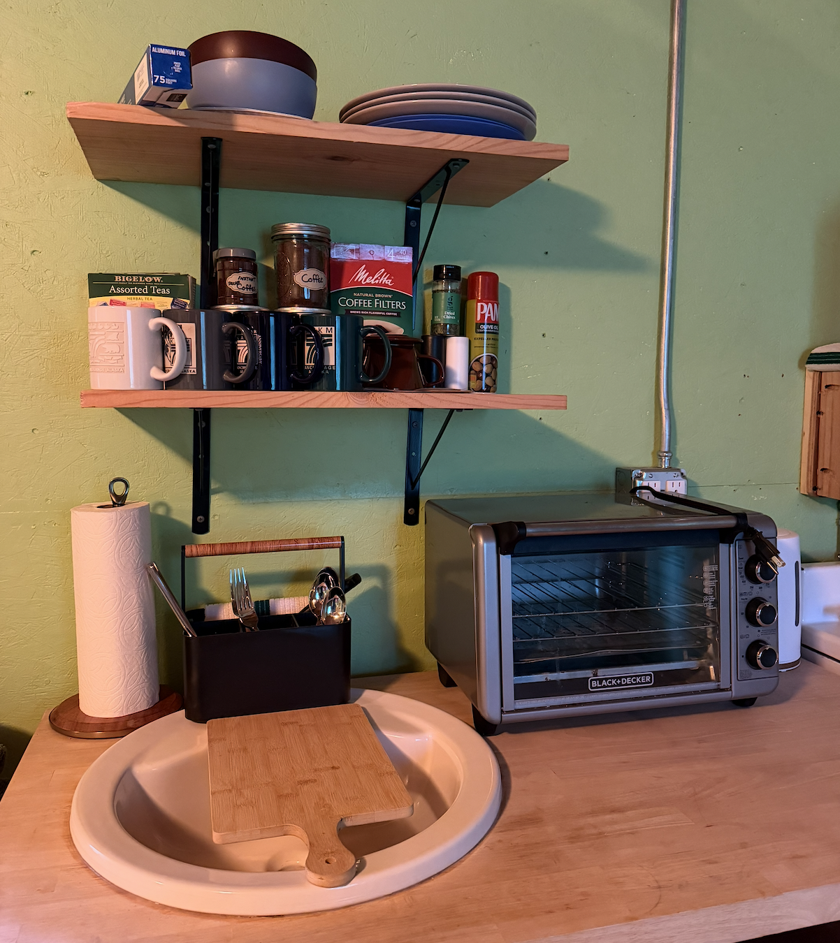 Caribou Cabin kitchenette, complete with toaster oven, electric kettle for coffee and tea, stovetop, and mini-fridge