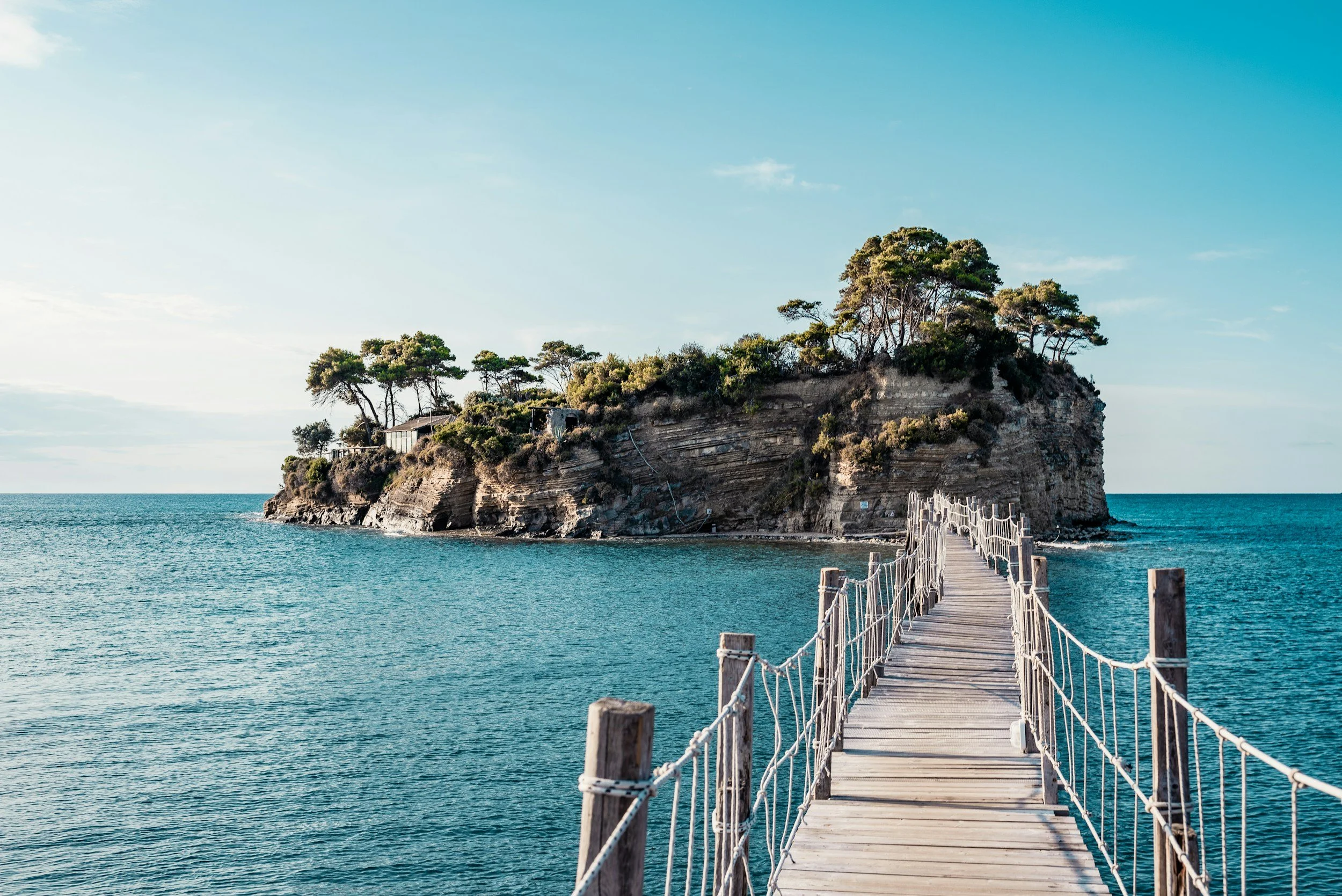 Boardwalk to island over clear blue water