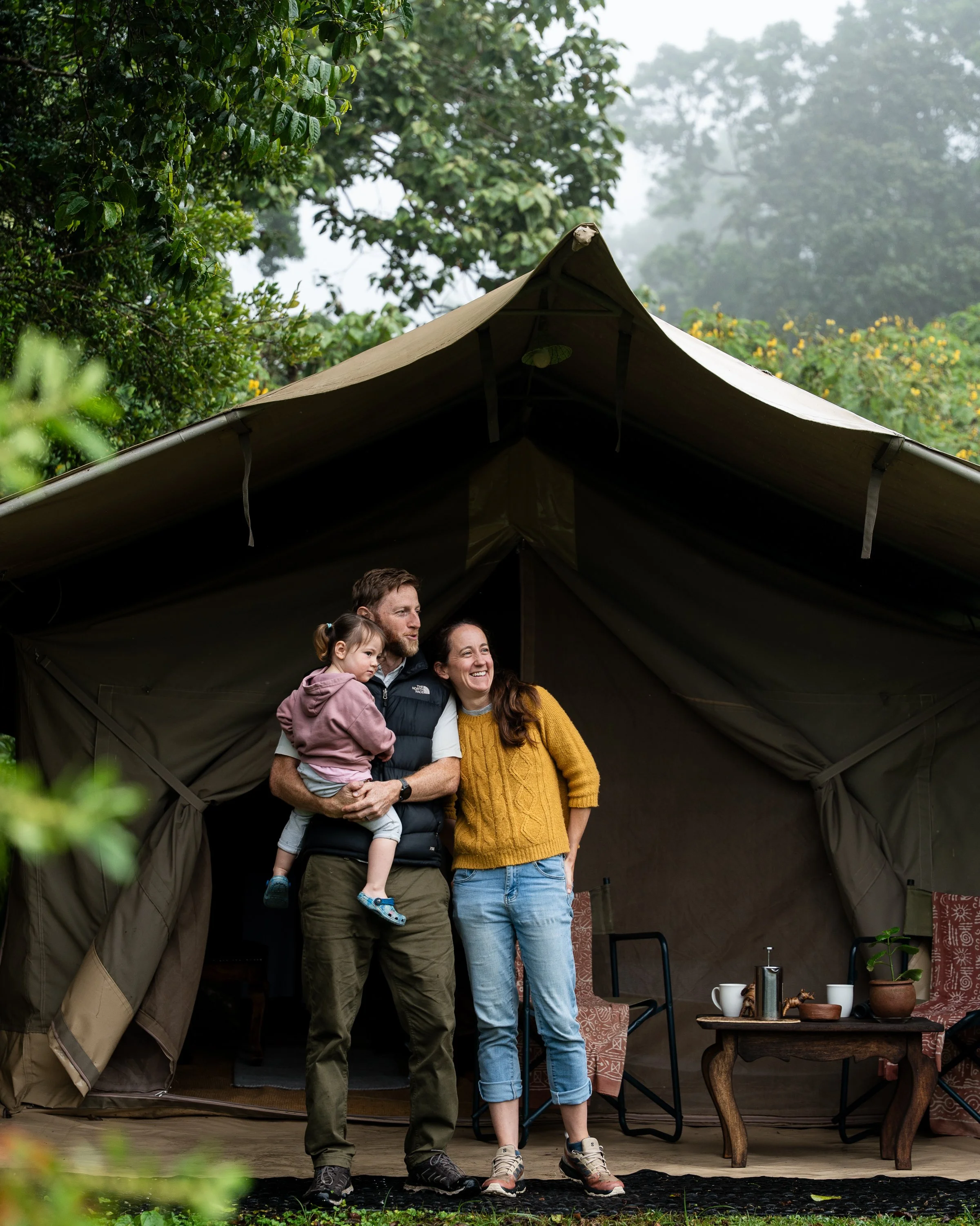 A family stood on the verandah of their tent on safari in Arusha National park