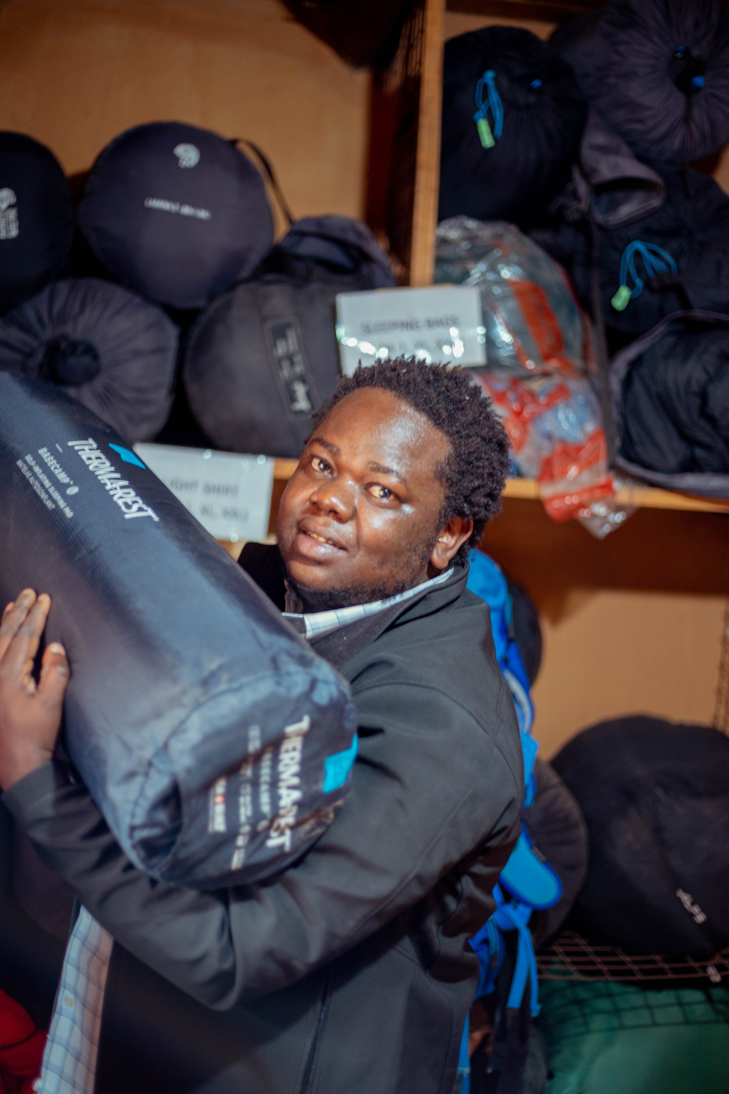 Man holding a sleeping bag in a store
