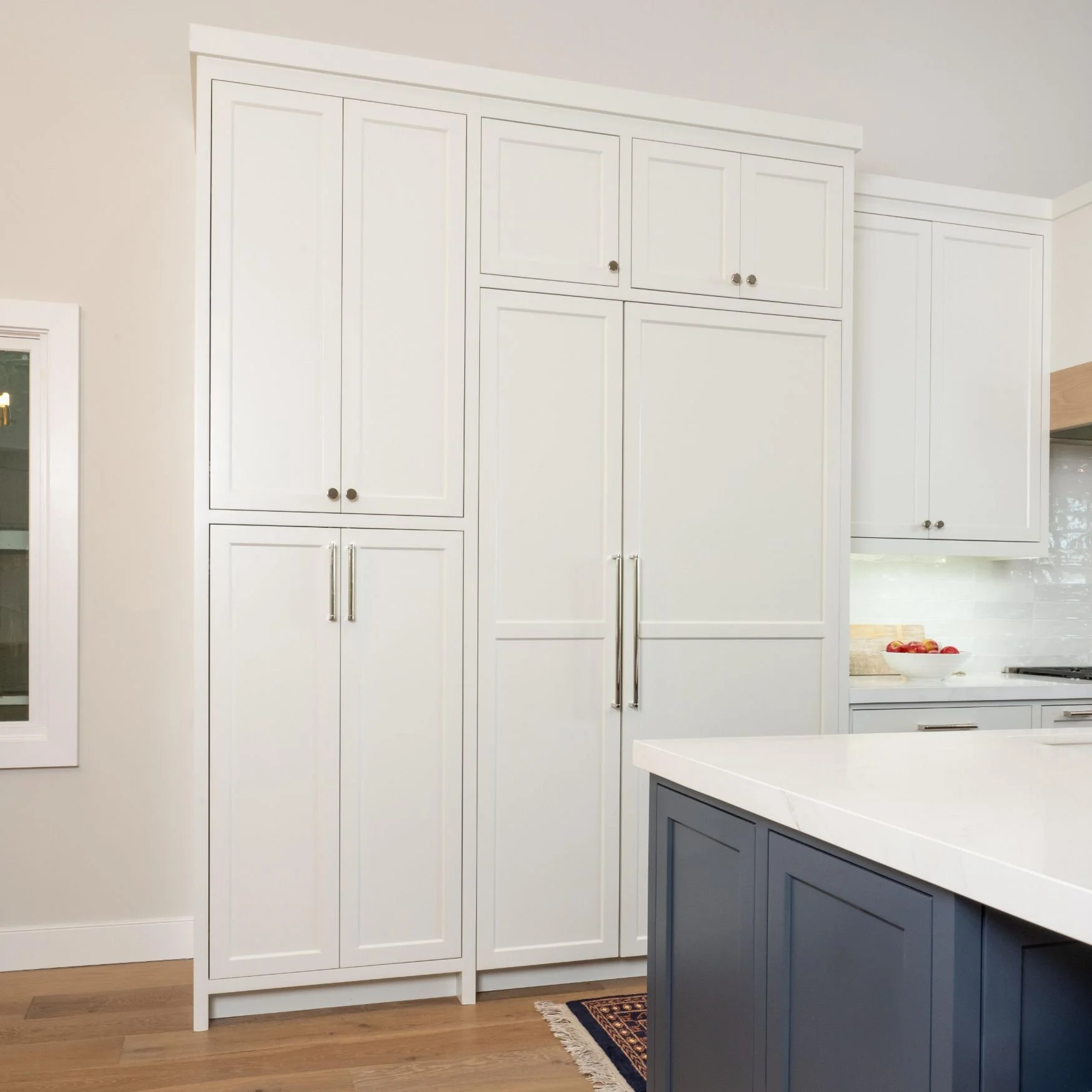 Large pantry cabinets and built in refrigerator in large kitchen 
