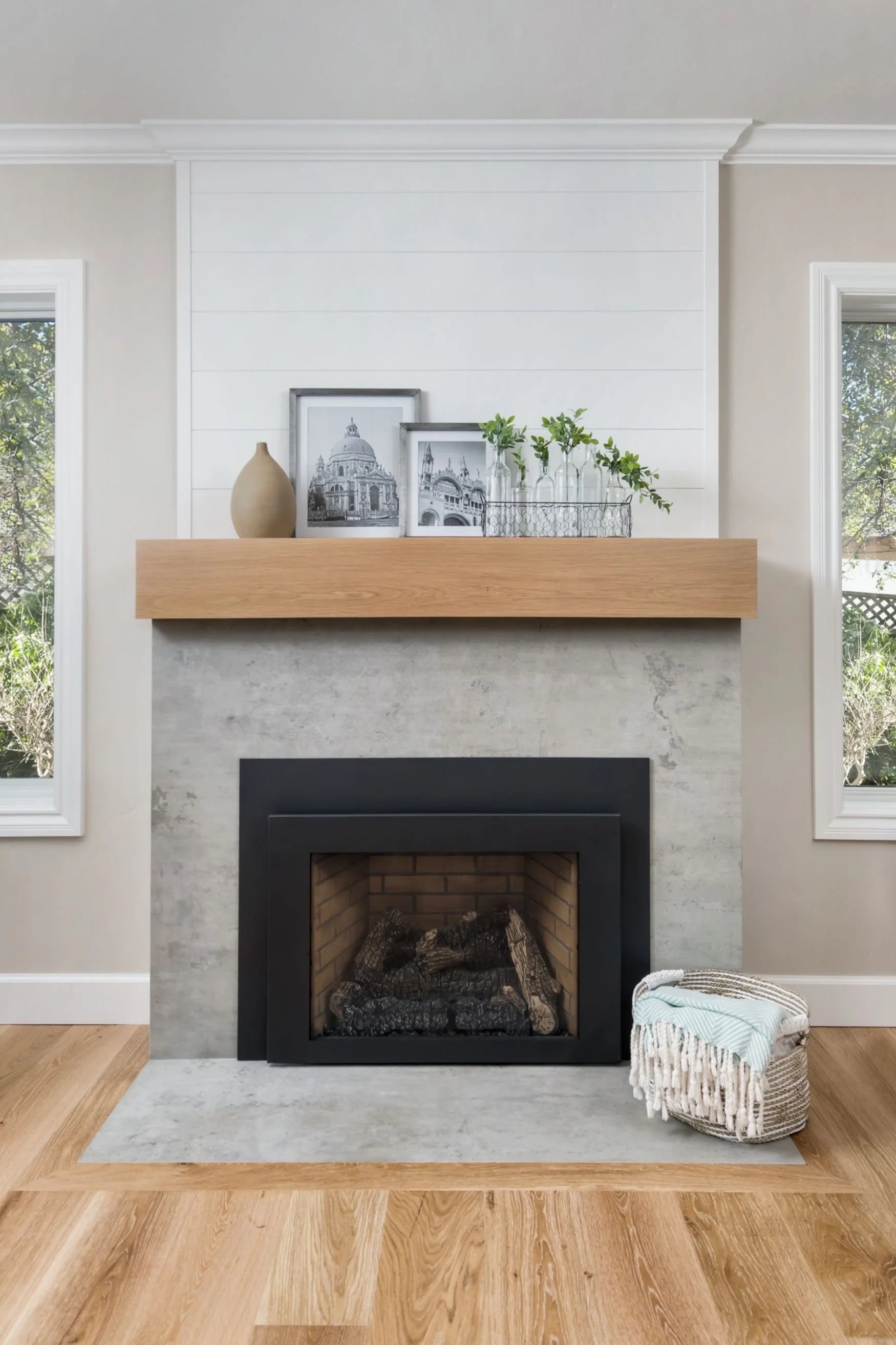 Farmhouse modern fireplace with oak mantel and concrete surround