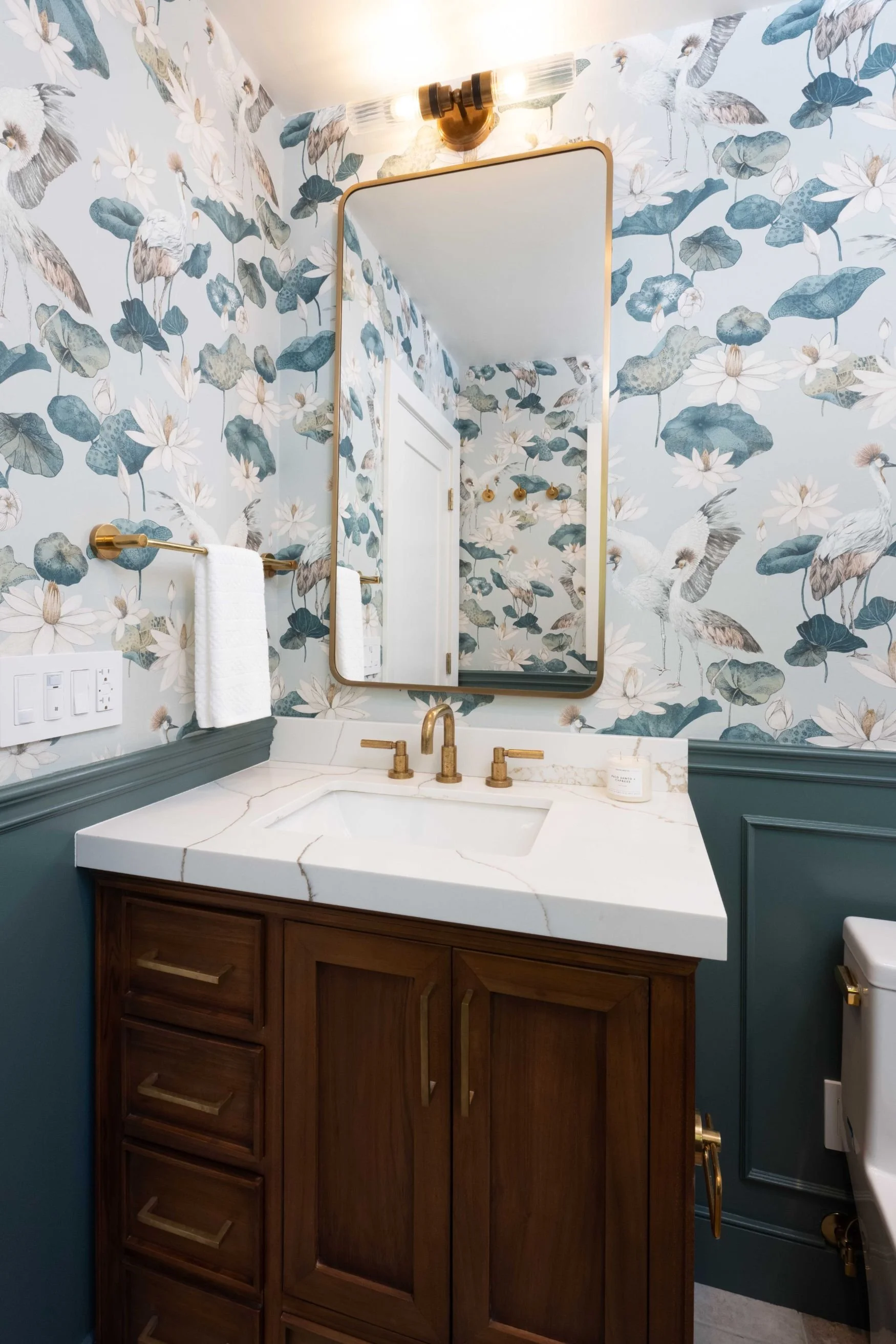 Powder bathroom with floral wallpaper and brown oak vanity