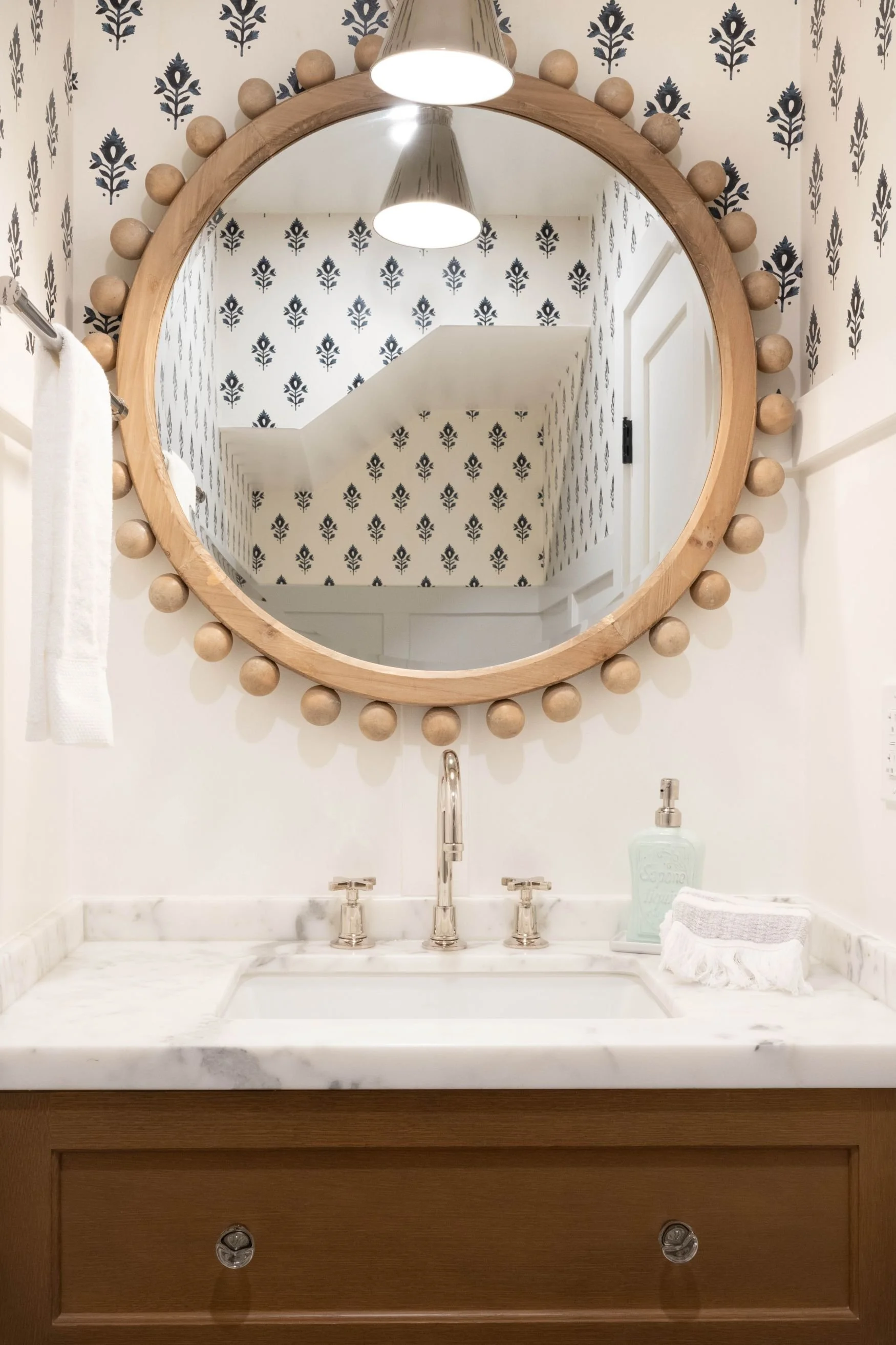 Powder bathroom with block print wallpaper and polished nickel fixtures