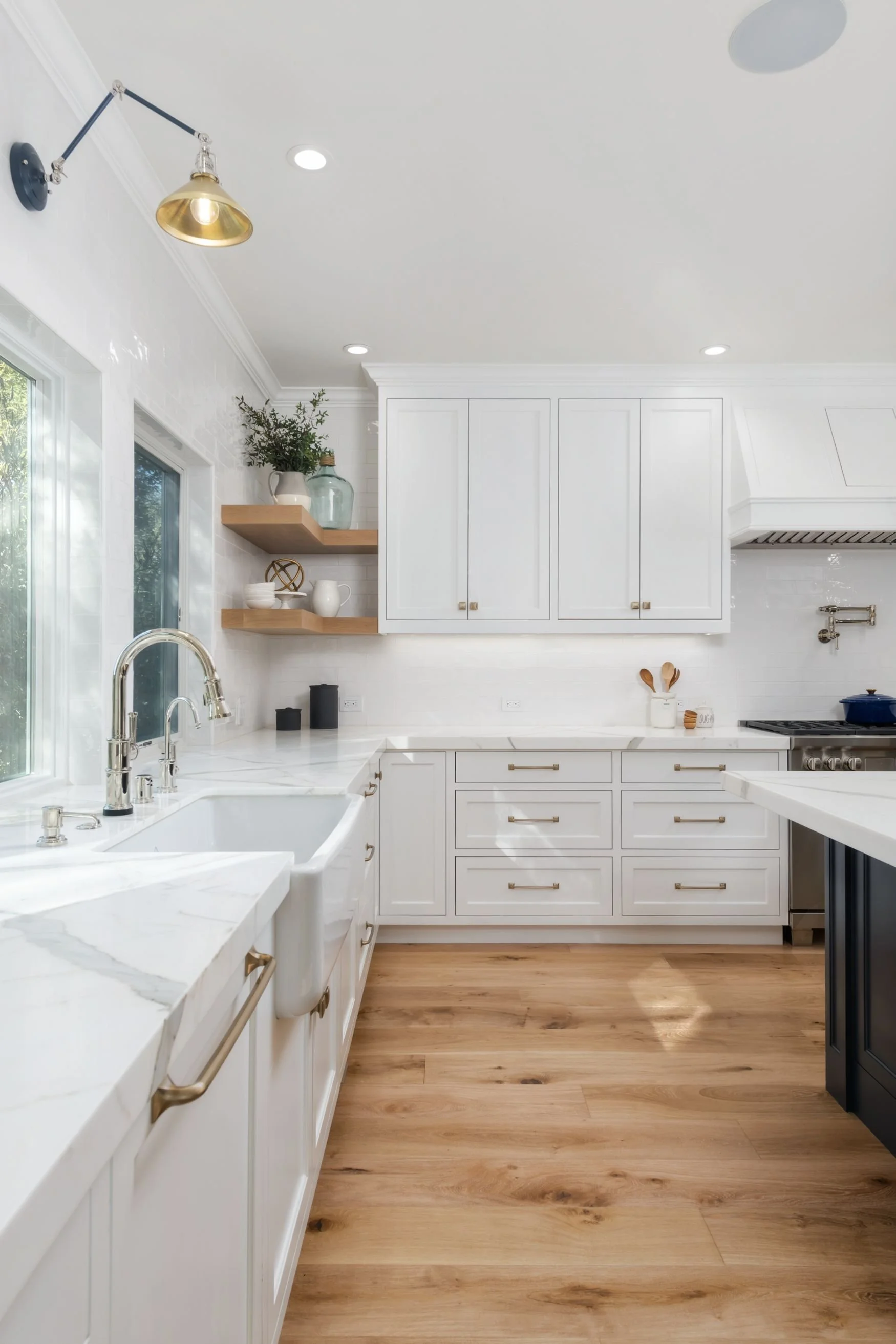 white and blue kitchen with oak flooring