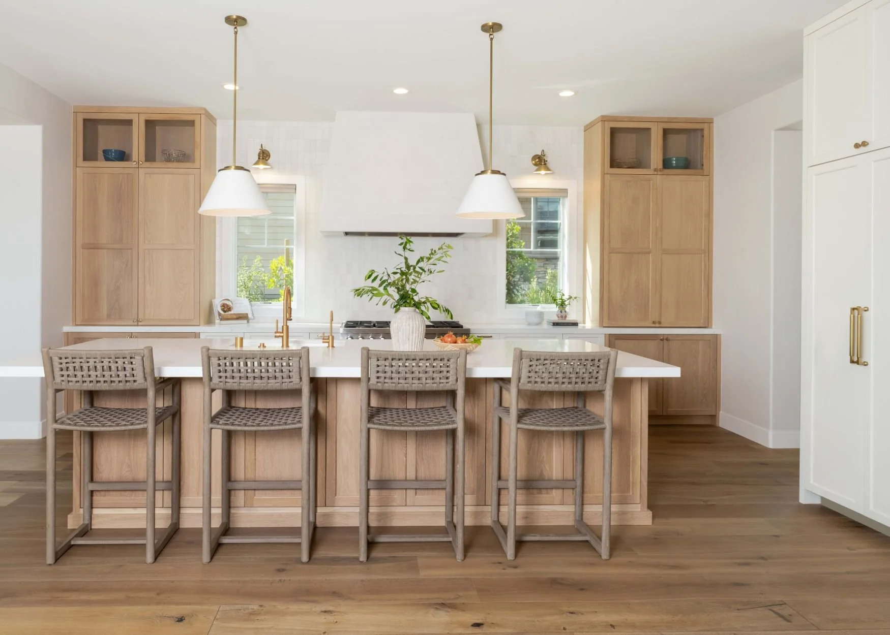 Large kitchen with plaster hood, large island, white and oak cabinetry