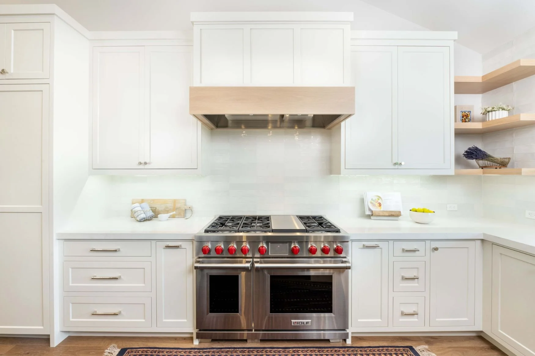 Wolf range with white cabinetry and oak hood in moraga, ca.