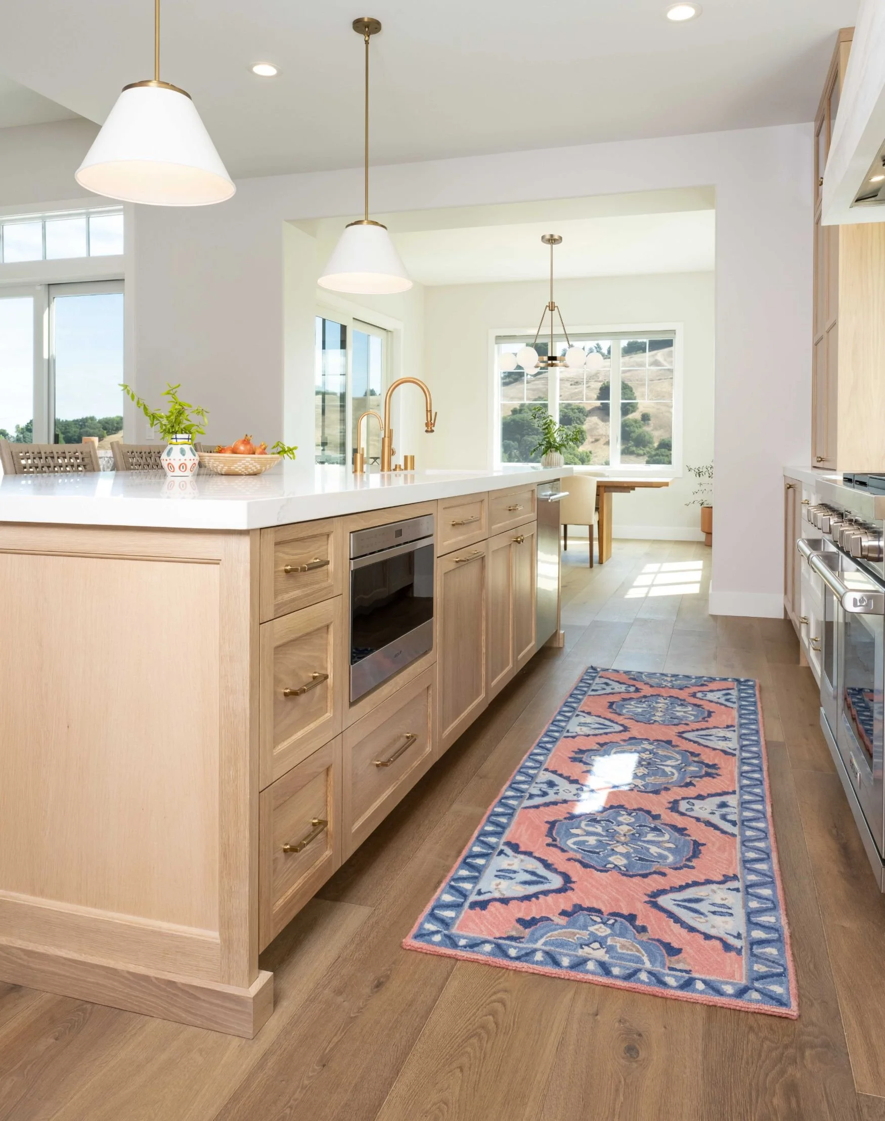 White oak island with microwave drawer and brass fixtures