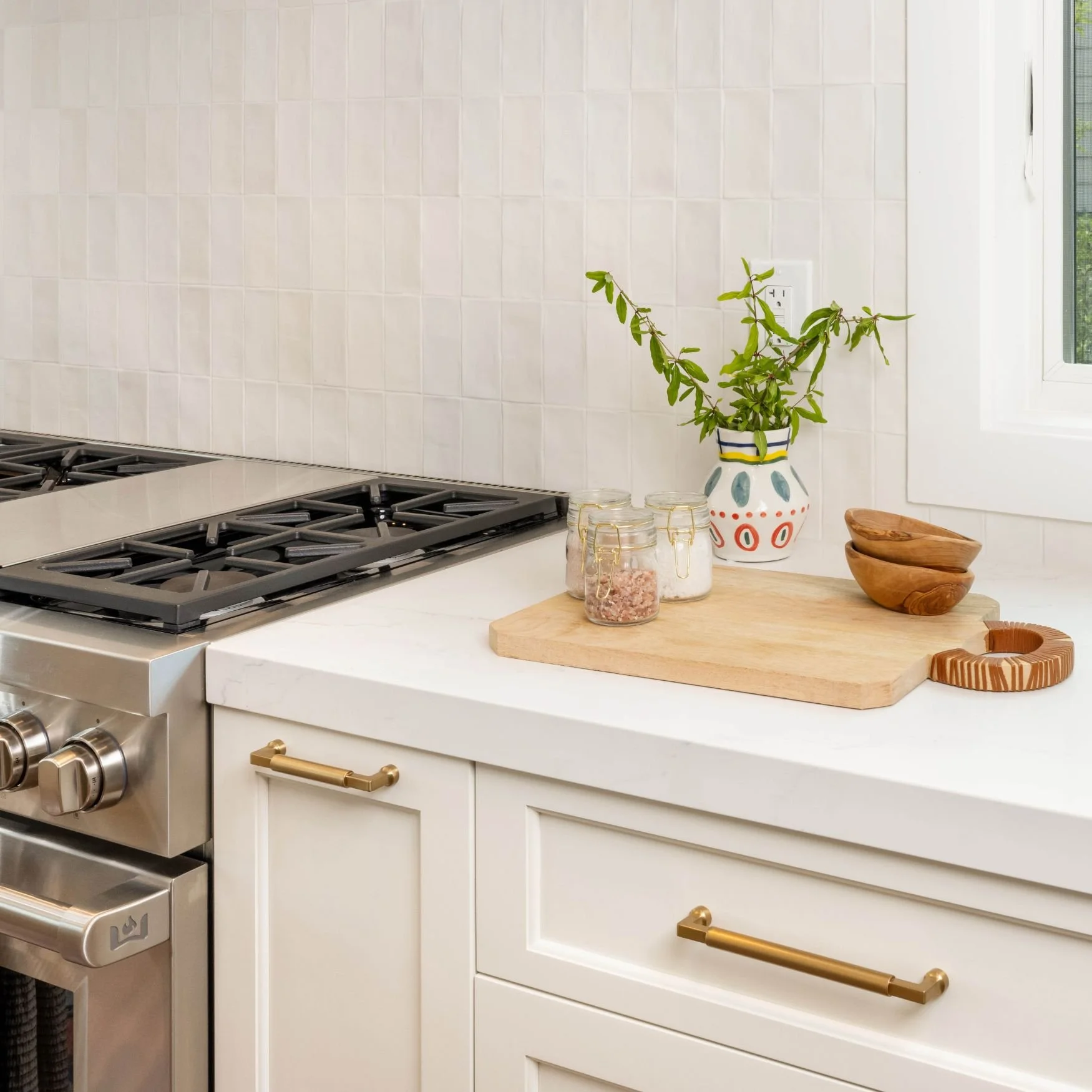 white cabinetry with white quartz countertop and brass cabinet hardware