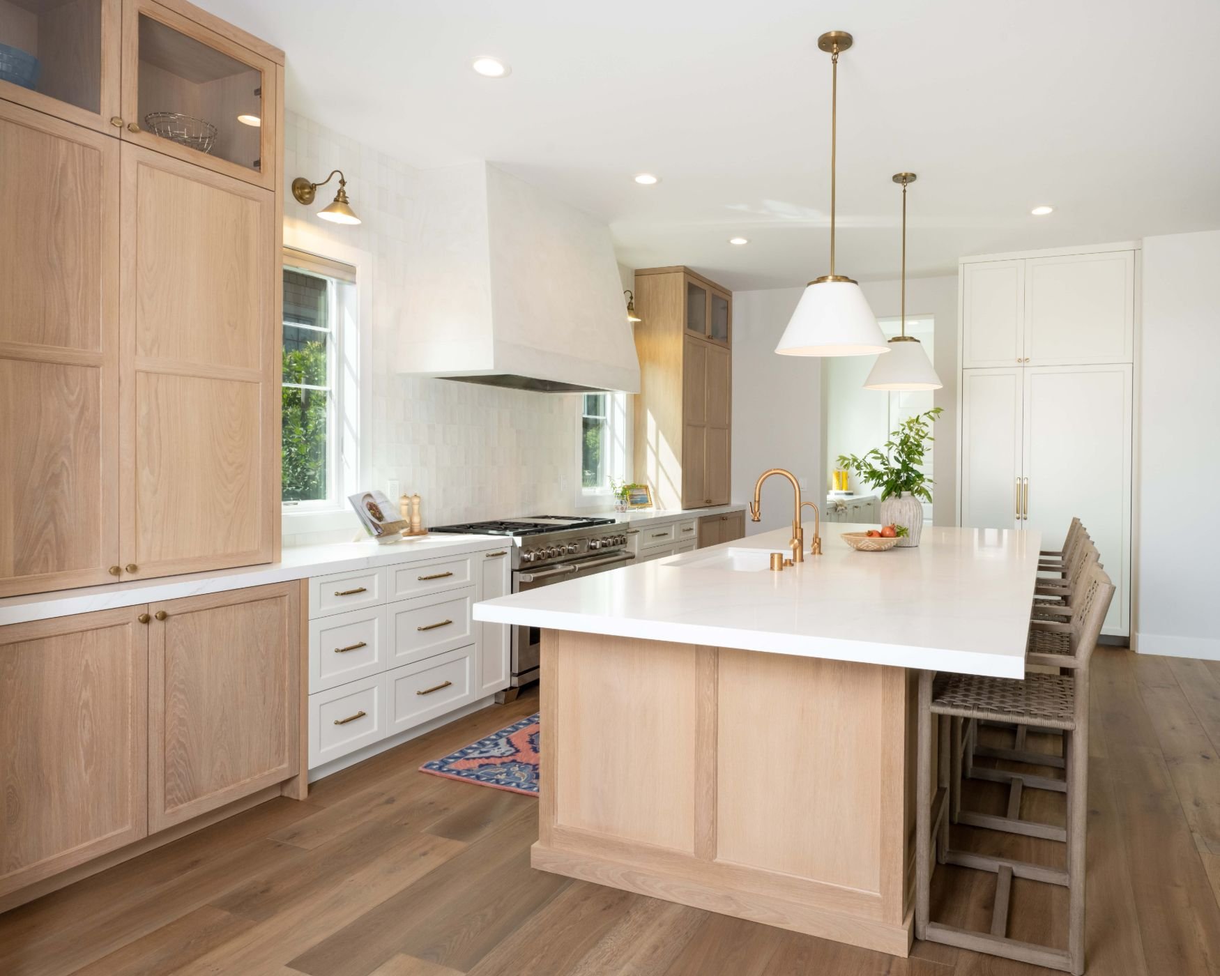 Large kitchen with two-tone cabinetry and white countertops