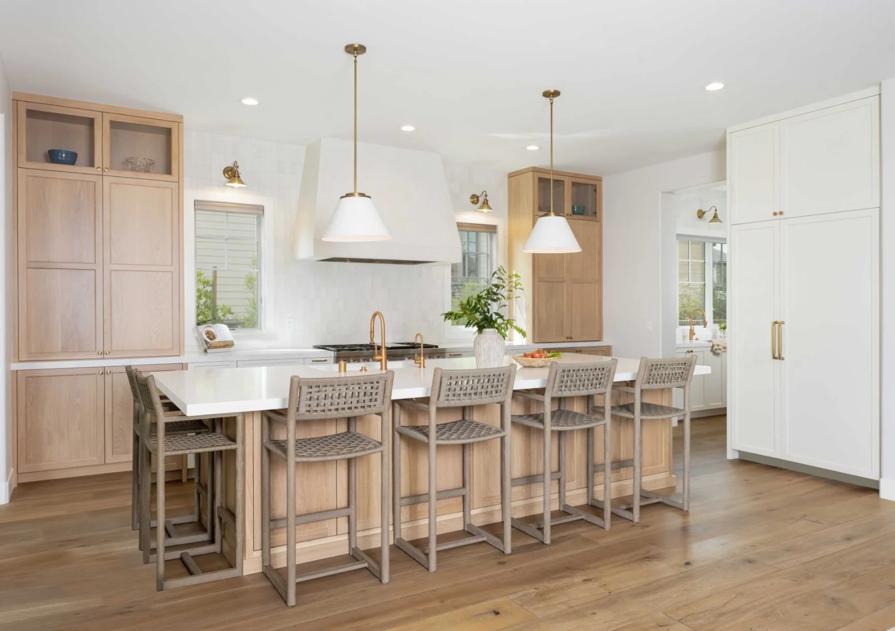 Large kitchen with plaster hood, large island, white and oak cabinetry