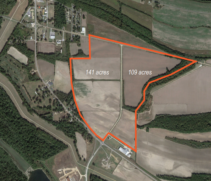 Aerial view of a large rural property with outlined boundary dividing it into smaller sections labeled 141 acres and 109 acres, surrounded by farmland, forests, and a residential area.