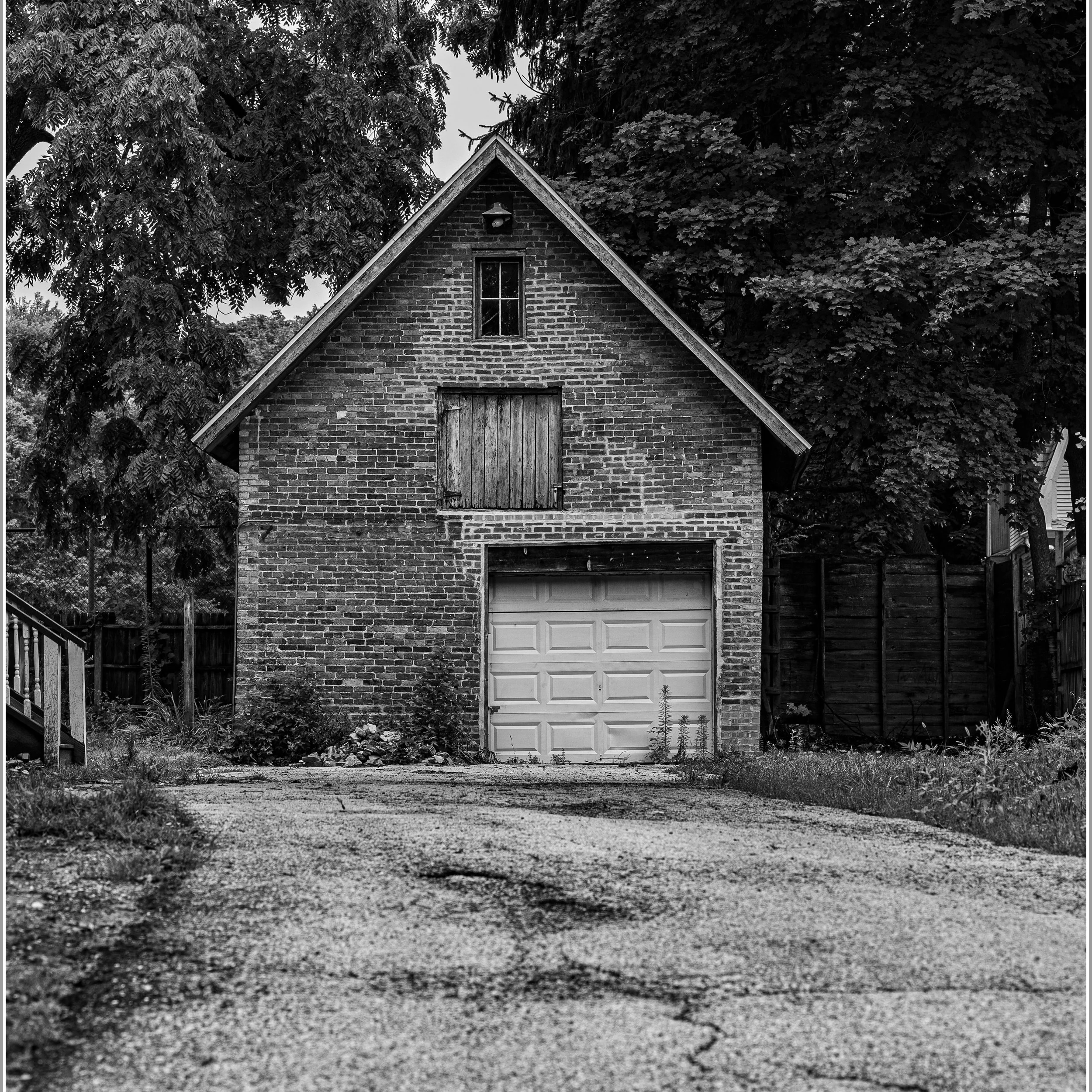 The detached garage could have been a Coach House at one time. The homeowner no longer uses it.