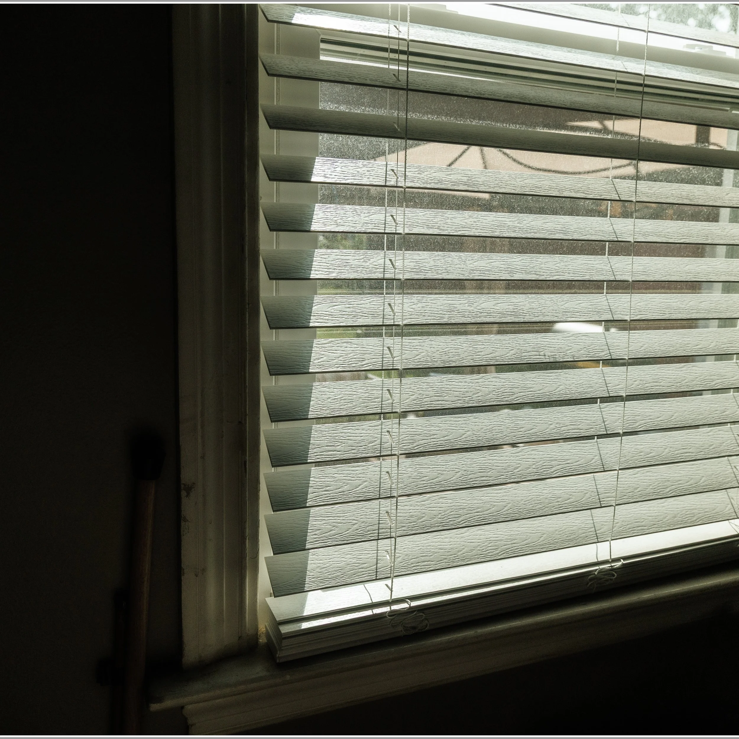 Natural light through a window shade. This is a color photo taken in my content room.