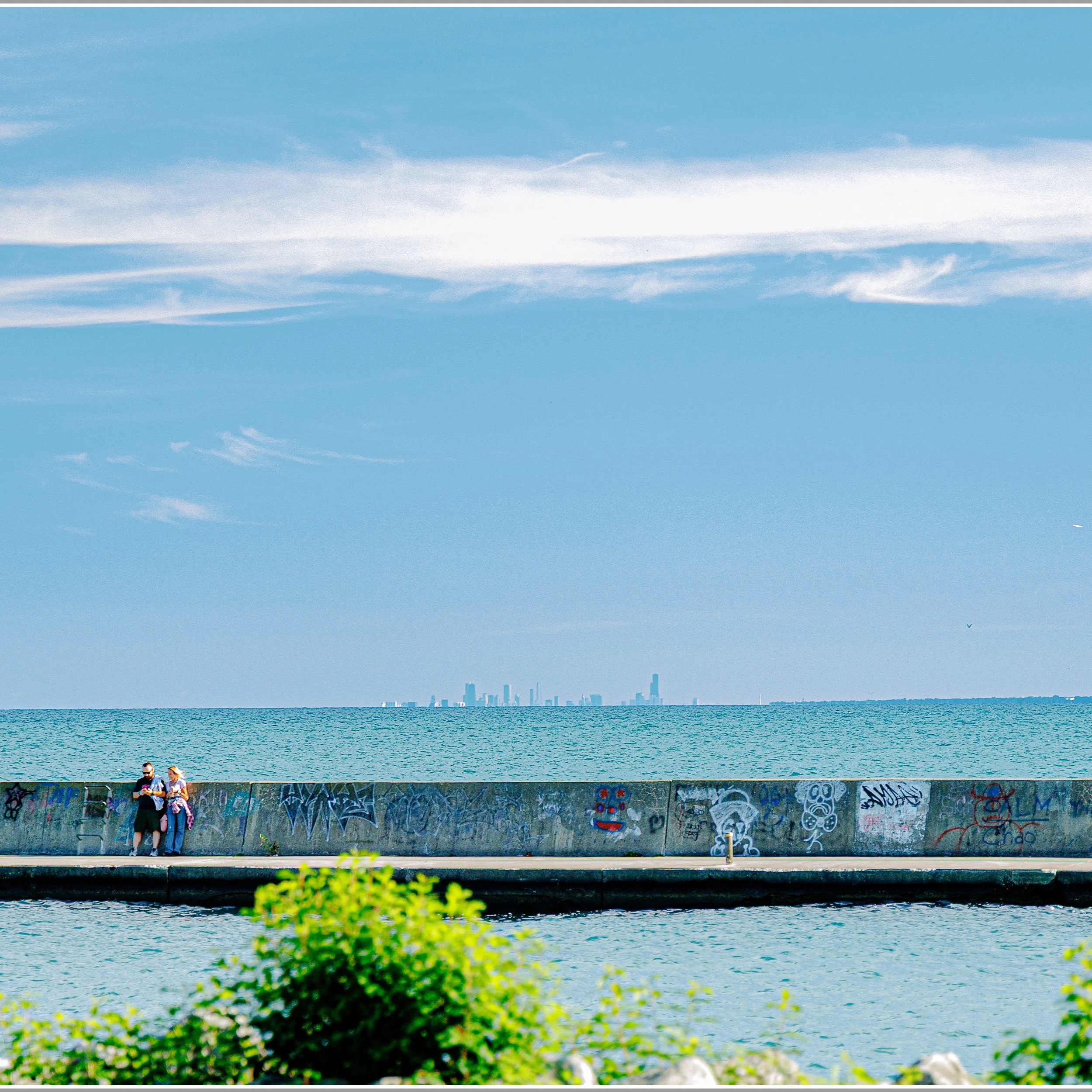 This photo was taken from Stiner Pavilion at Waukegan Beach. Waukegan is a small city 43 miles north of downtown Chicago. In the distance is the Chicago Skyline of Giants. Willis Tower (formerly Sears Tower) is on the right. Moving to the left are th