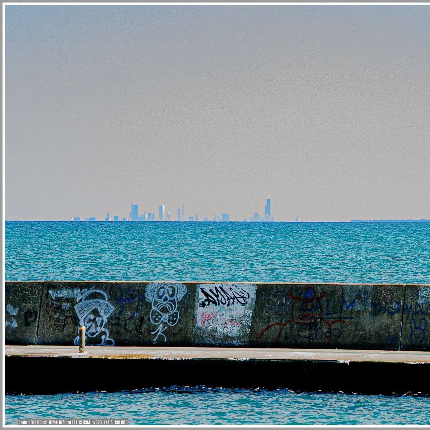 This photo was taken from Stiner Pavilion at Waukegan Beach, one hour later, as the sun was setting. This cropped close-up shows the sun's reflection on some of the Chicago Giants. 
Waukegan is a small city 43 miles north of downtown Chicago. In the 