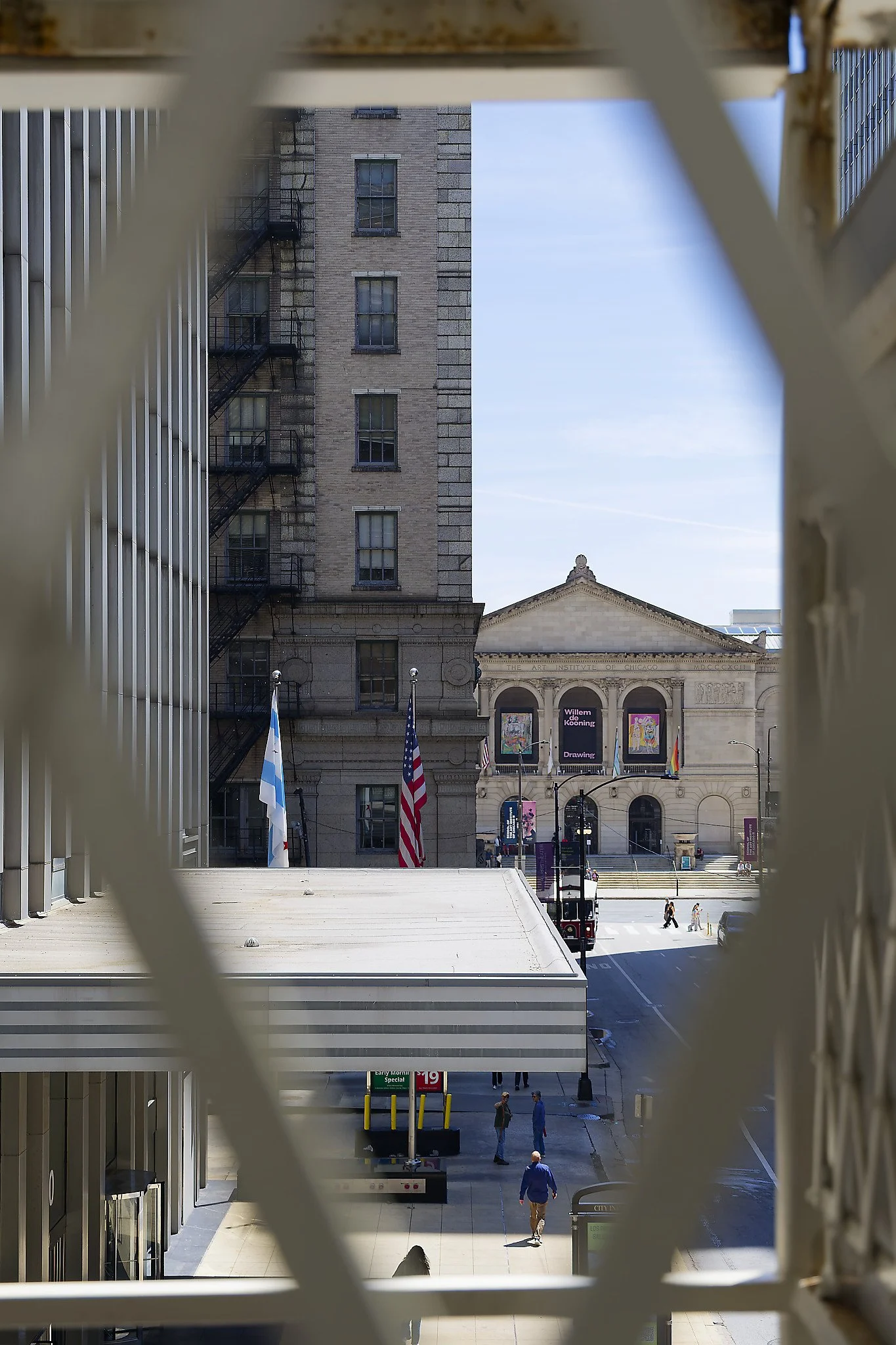 The Chicago Art Institute, through the gated fence at the Washington and Wabash elevated train station.