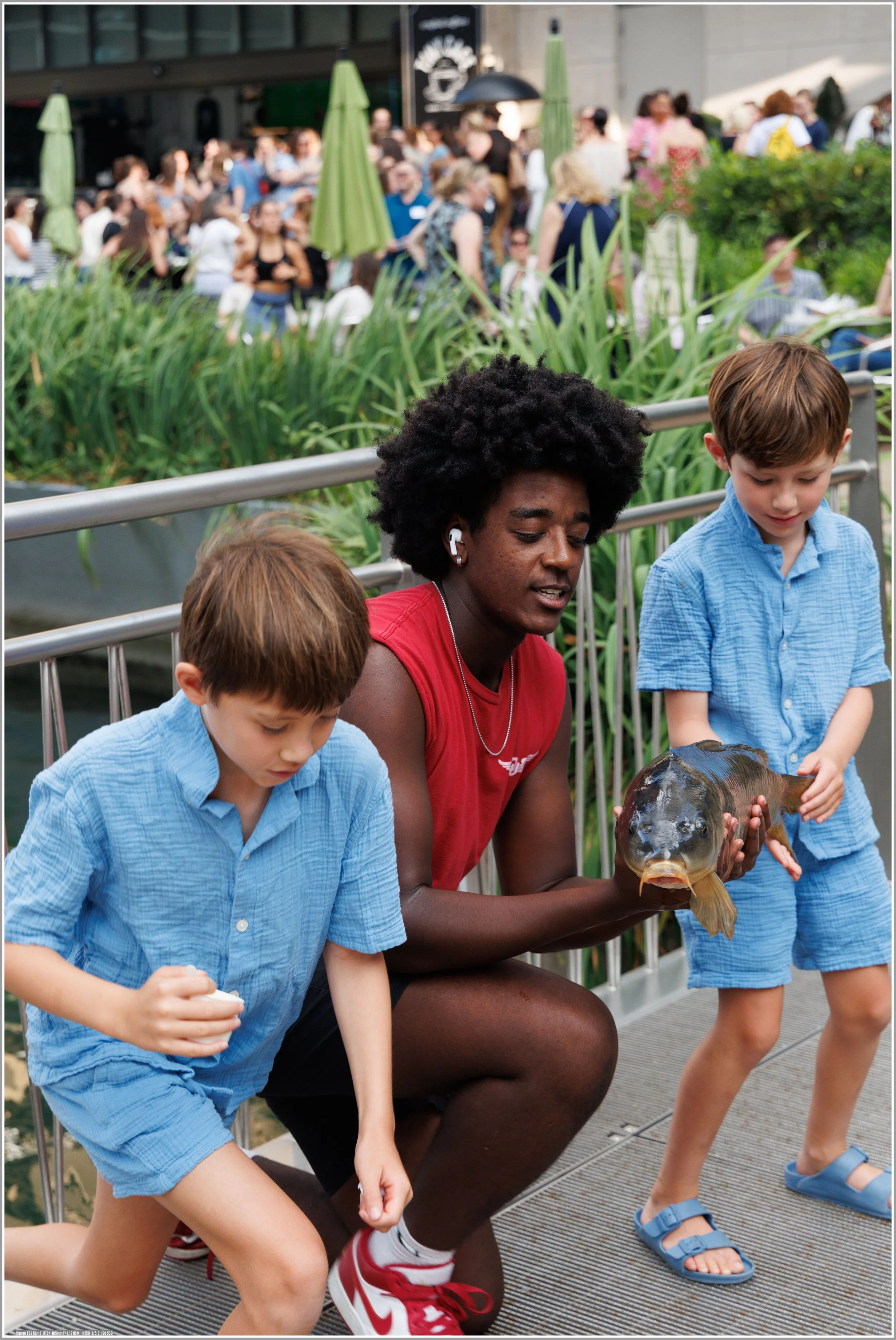 Zack is sharing his catch with two young boys