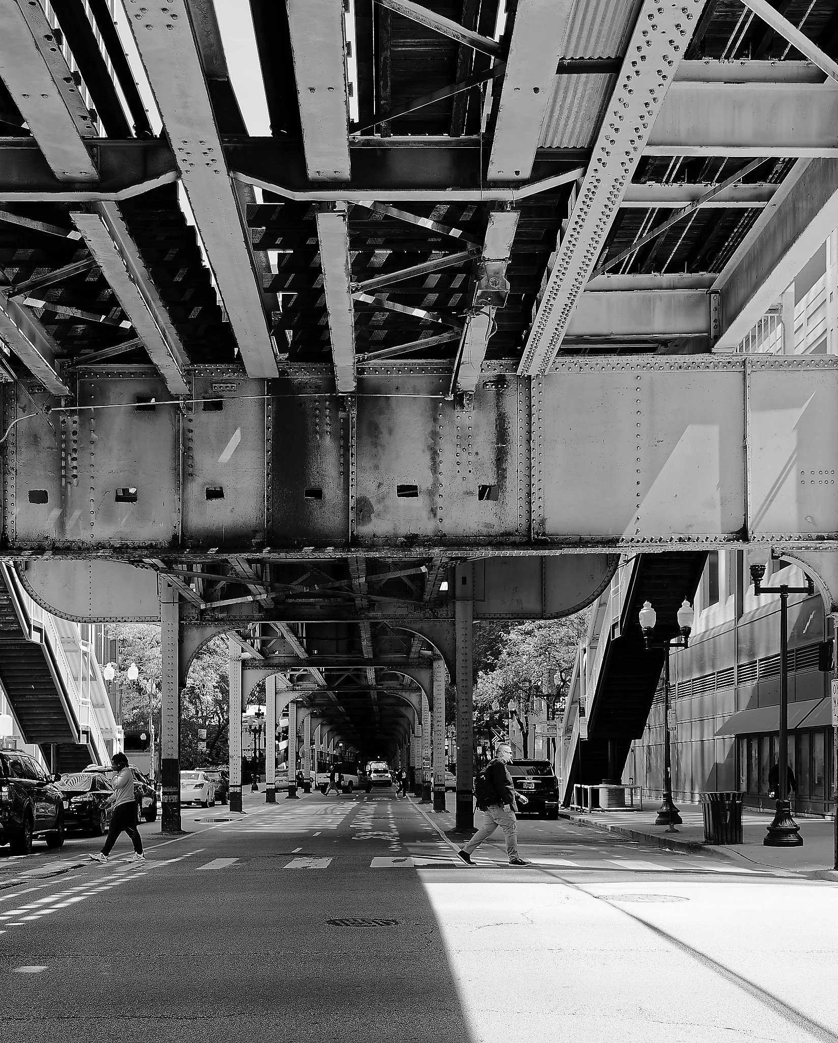 Light and shadow underneath the elevated tracks at the Chicago Merchandise Mart station