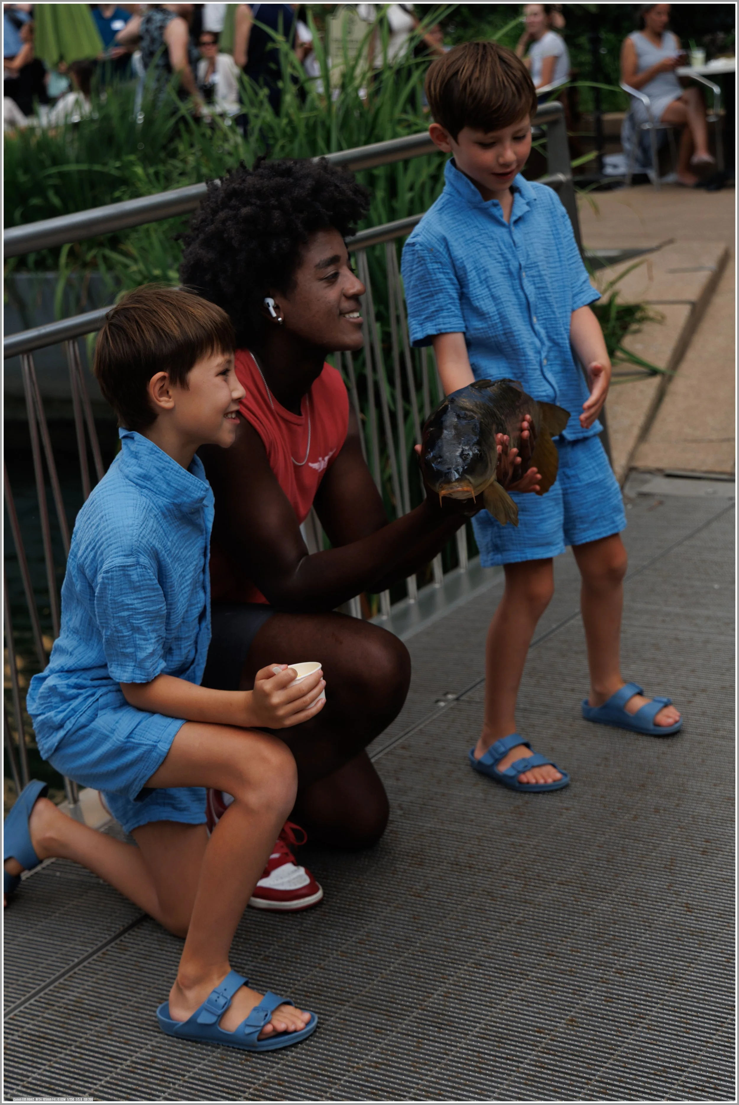 Zack is sharing his catch with two young boys