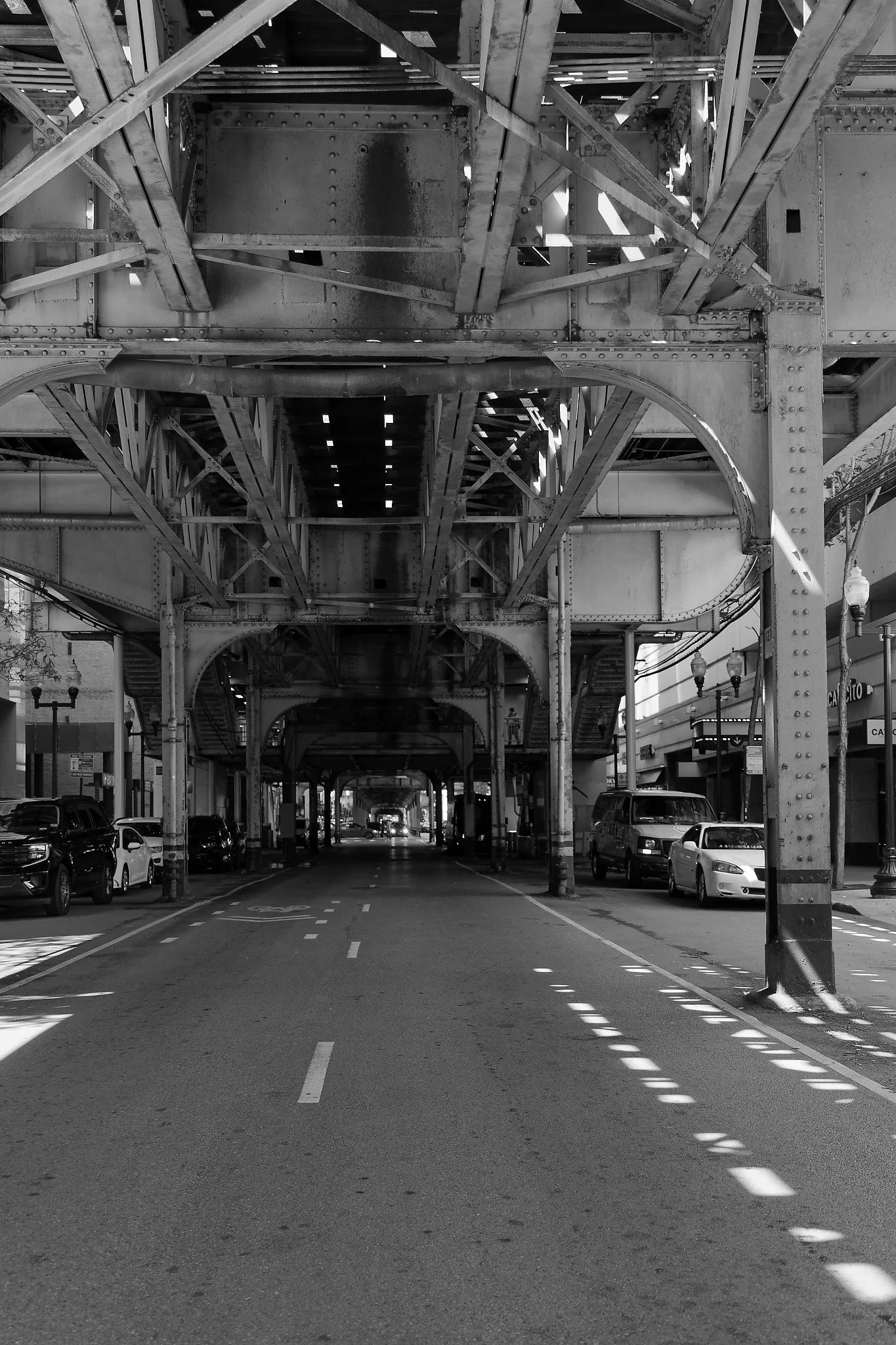 Light and shadow under neath the elevated tracks at Merchandise Mart station