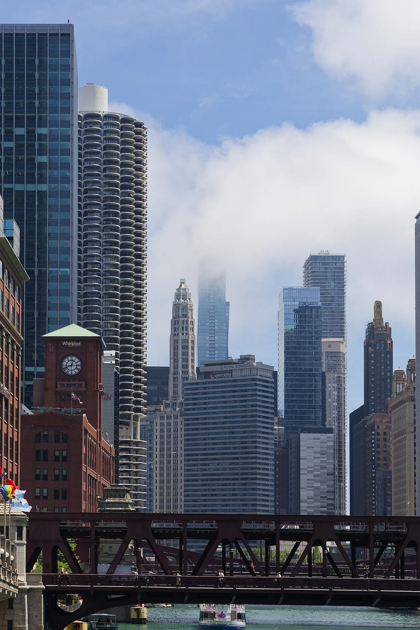 Low-hanging clouds from the lake are hiding the upper floors of The St. Regis Chicago. The blue glass building sits on the southern side of the Chicago River.
To reduce wind sway, the tower features "blow-through" floors, including one on level 83, a