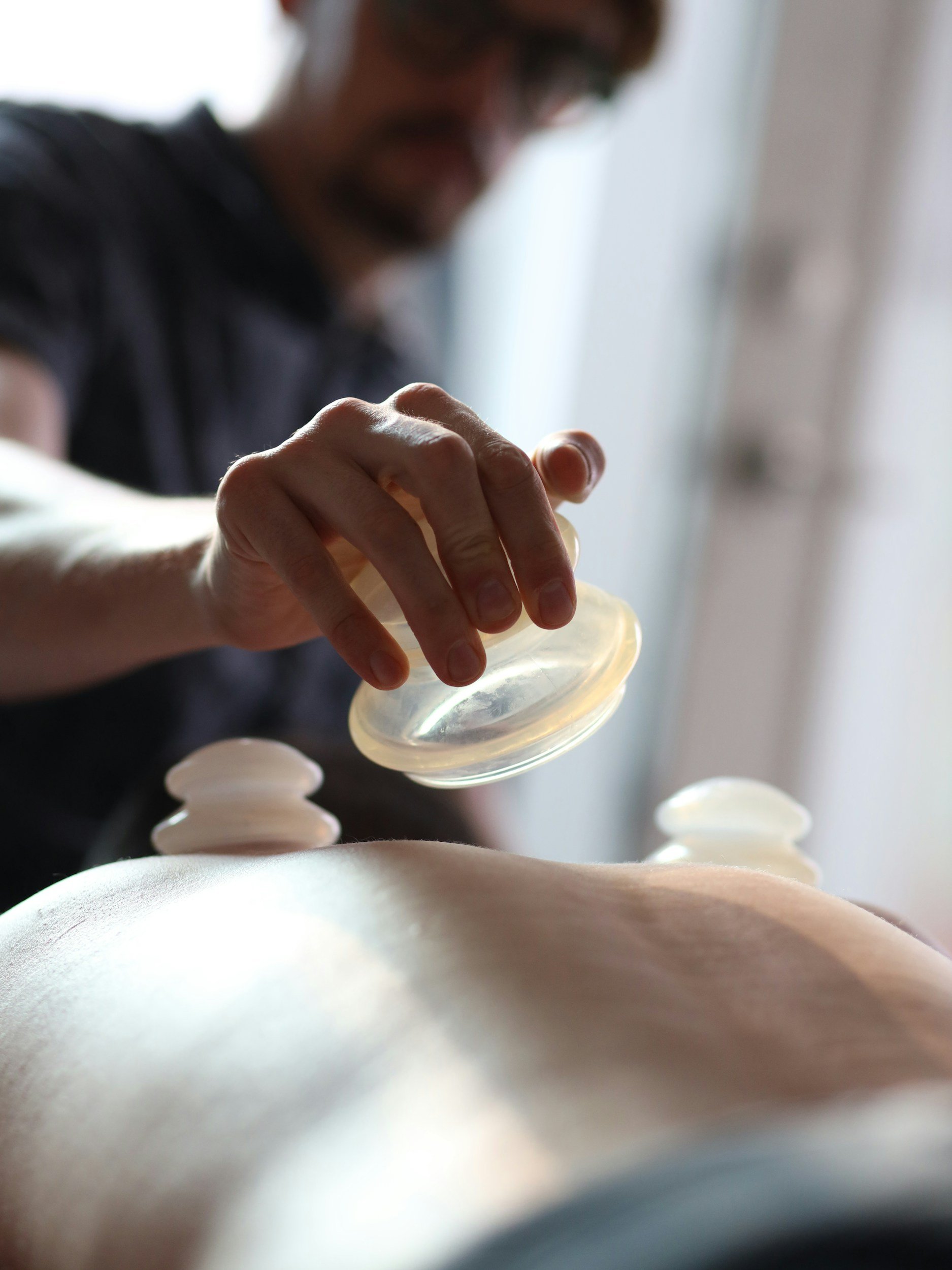 Close-up of a person performing silicone cupping on the body